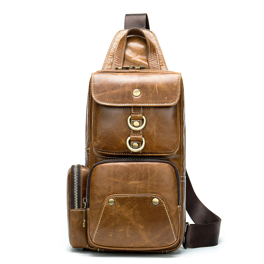 Brown leather chest bag with soft surface, featuring zipper closure and internal pockets for organization.