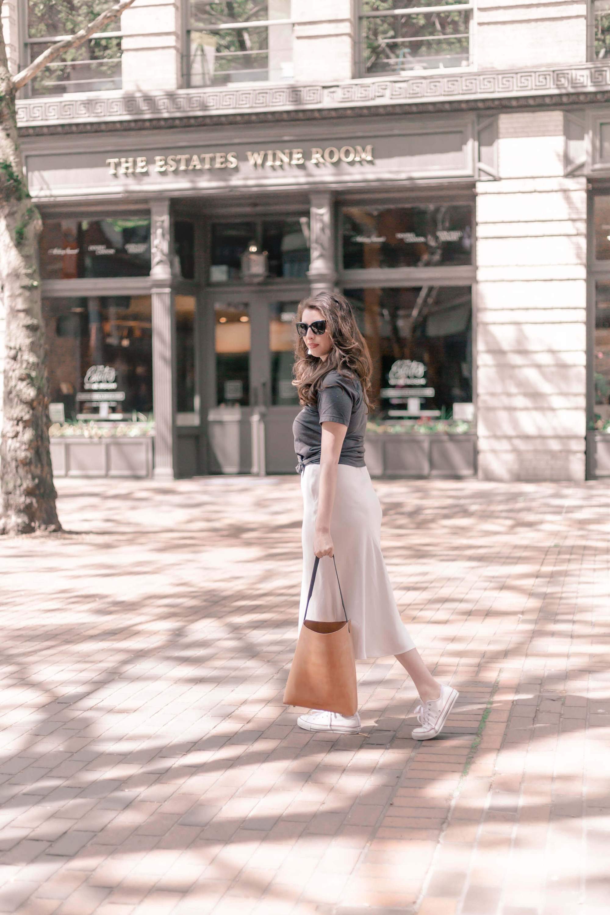 A handcrafted Bucket Tote made from vegtan leather, featuring a minimalist design and unlined interior, perfect for carrying a 13" laptop.