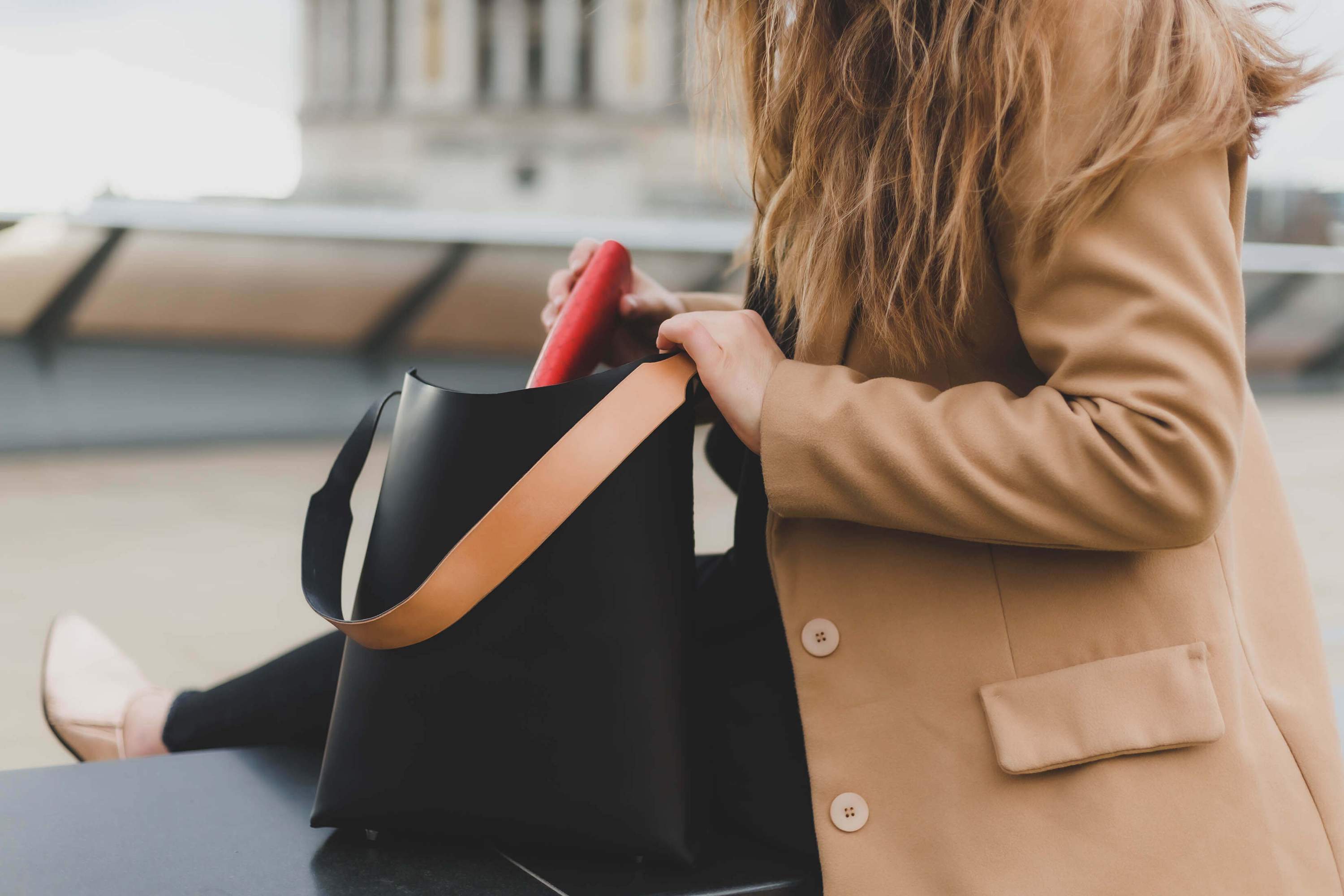 A handcrafted Bucket Tote made from vegtan leather, featuring a minimalist design and unlined interior, perfect for carrying a 13" laptop.