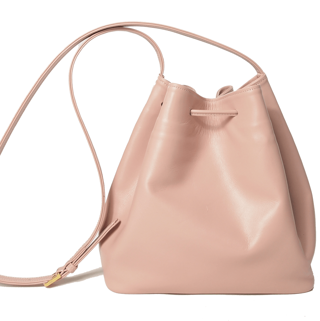 Buffed Leather Bucket Bag in Dusty-Rose with fringed straps and gold studs, showcasing its elegant design and premium Italian calfskin material.