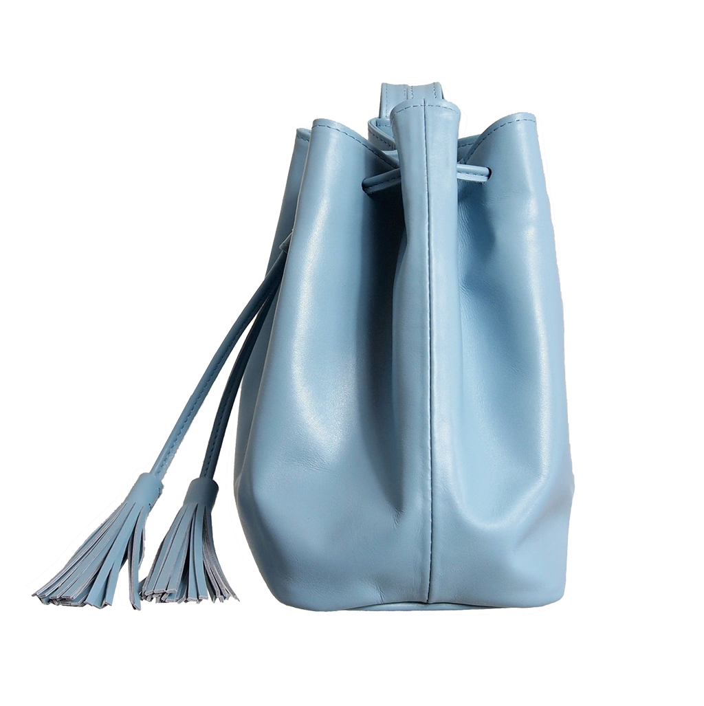 Sky-blue buffed leather bucket bag with fringed straps and gold studs, featuring a spacious cotton interior and zipped compartment.