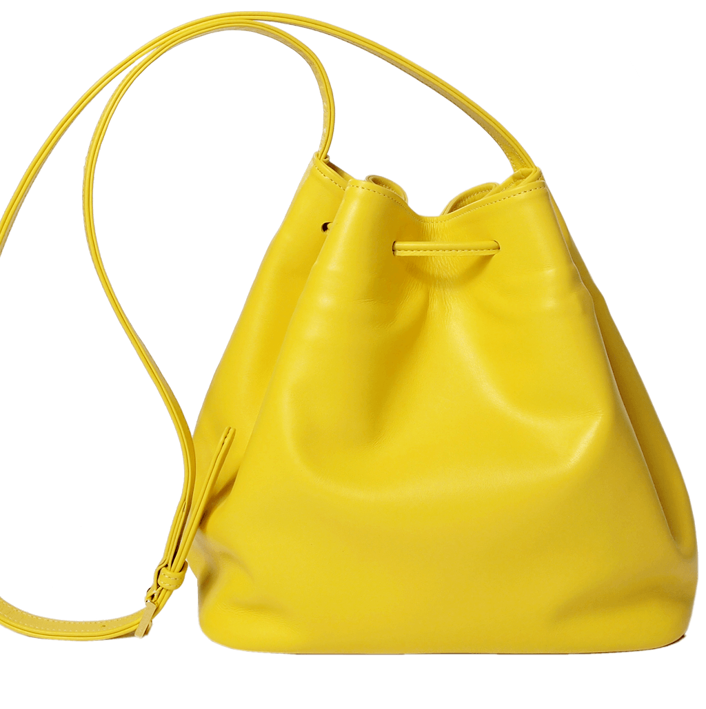 Buffed Leather Bucket Bag in Yellow with fringed straps and gold studs, showcasing its spacious cotton interior and elegant design.