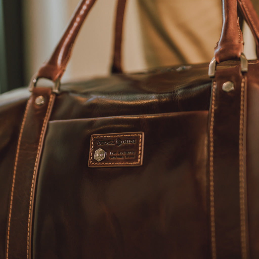 Cabin Wheeled Holdall 55cm in Tobacco color, showcasing its stylish design and durable wheels.