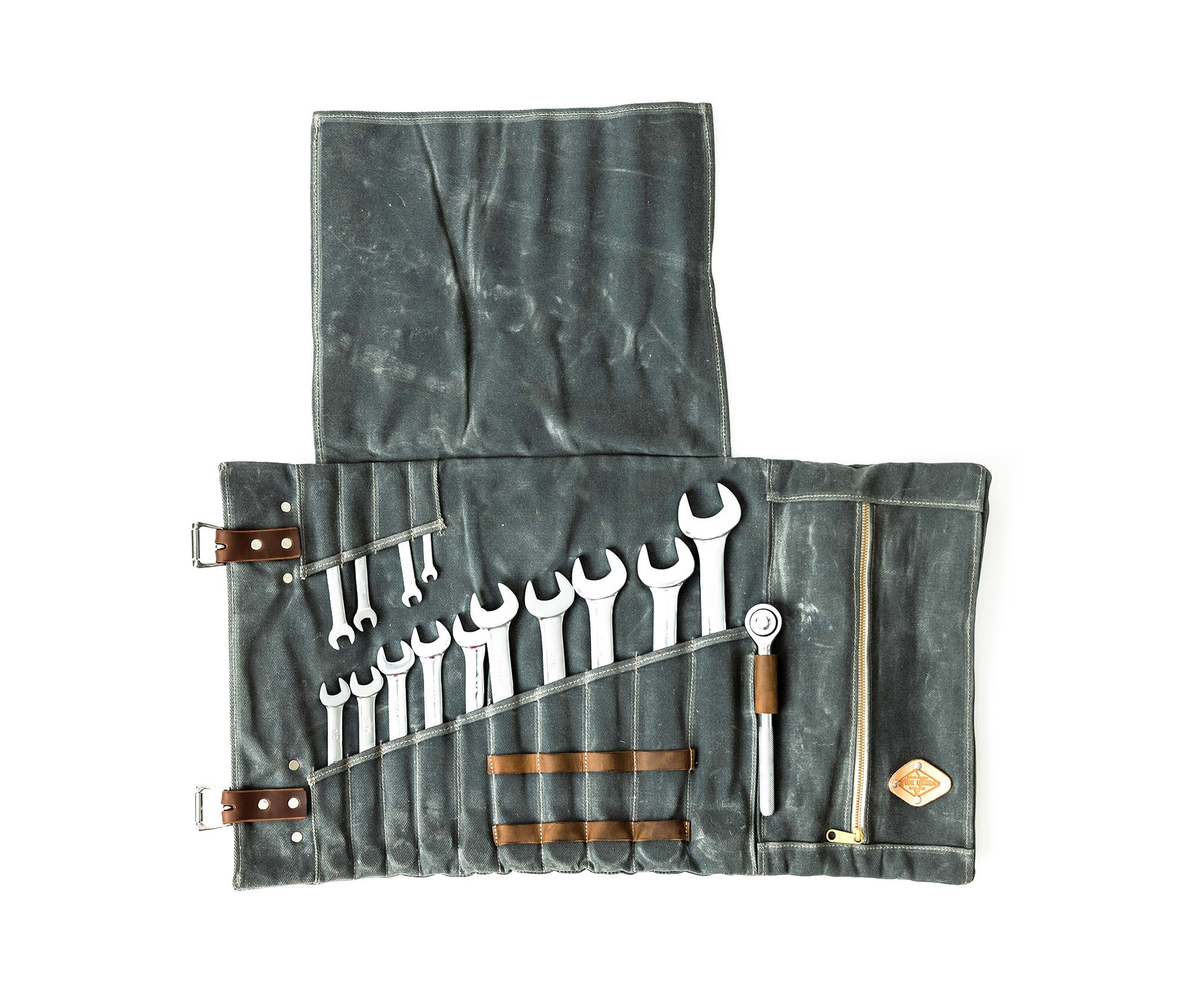 Canvas Tool Roll featuring waxed canvas and leather accents, designed to hold wrenches and tools securely.