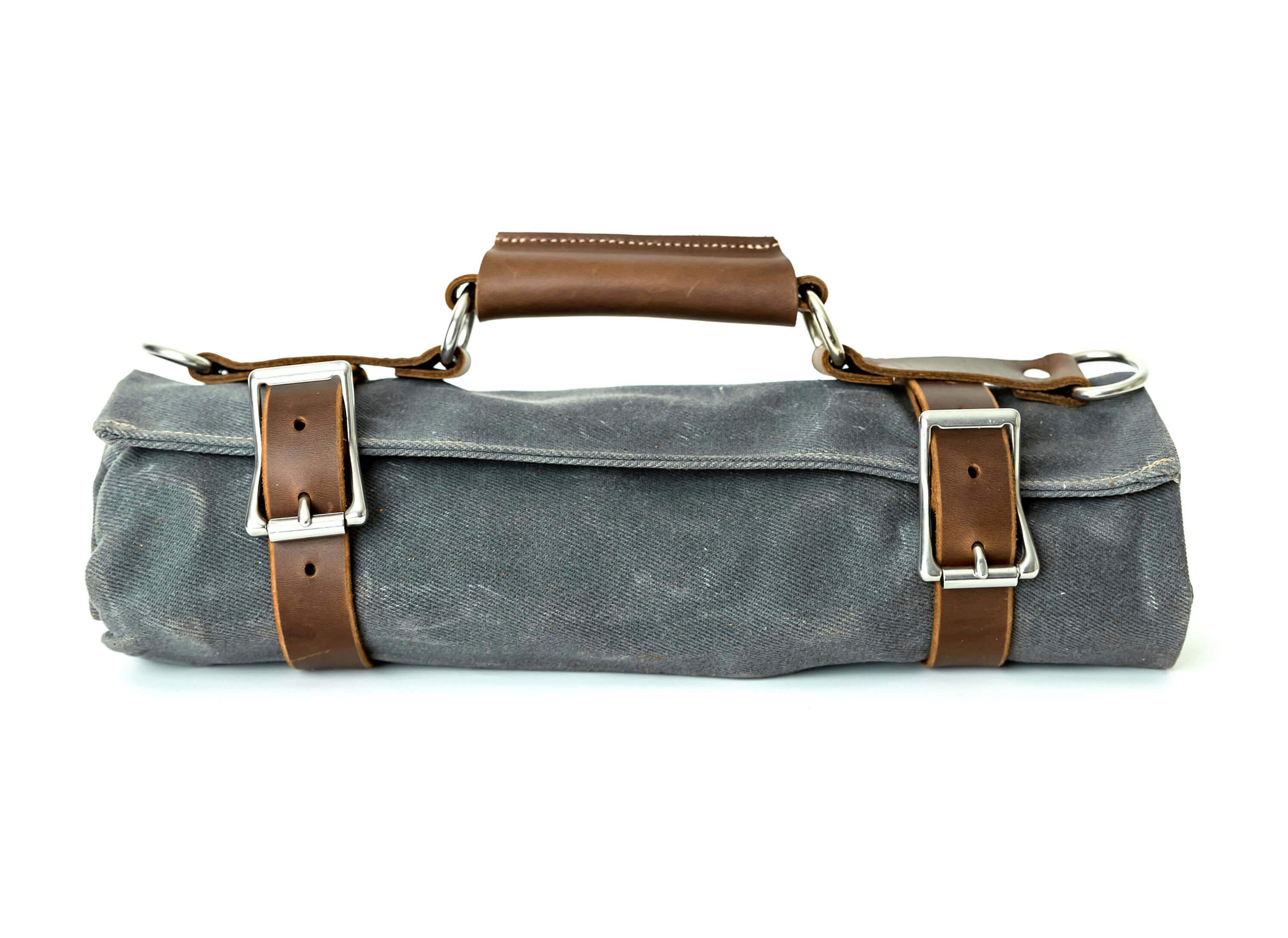 Canvas Tool Roll featuring waxed canvas and leather accents, designed to hold wrenches and tools securely.