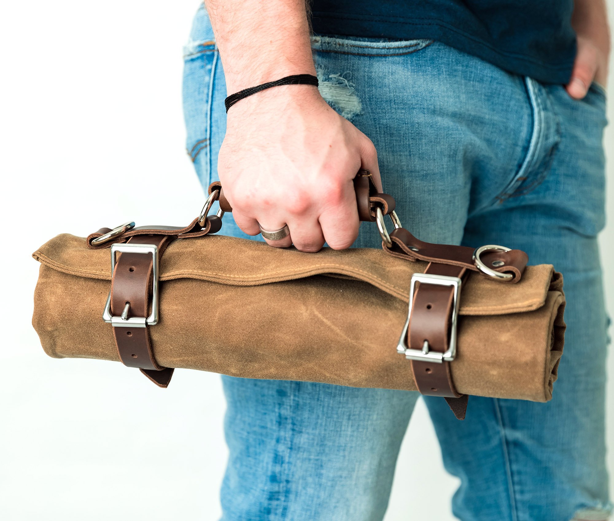 Canvas Tool Roll featuring waxed canvas and leather accents, designed to hold wrenches and tools securely.