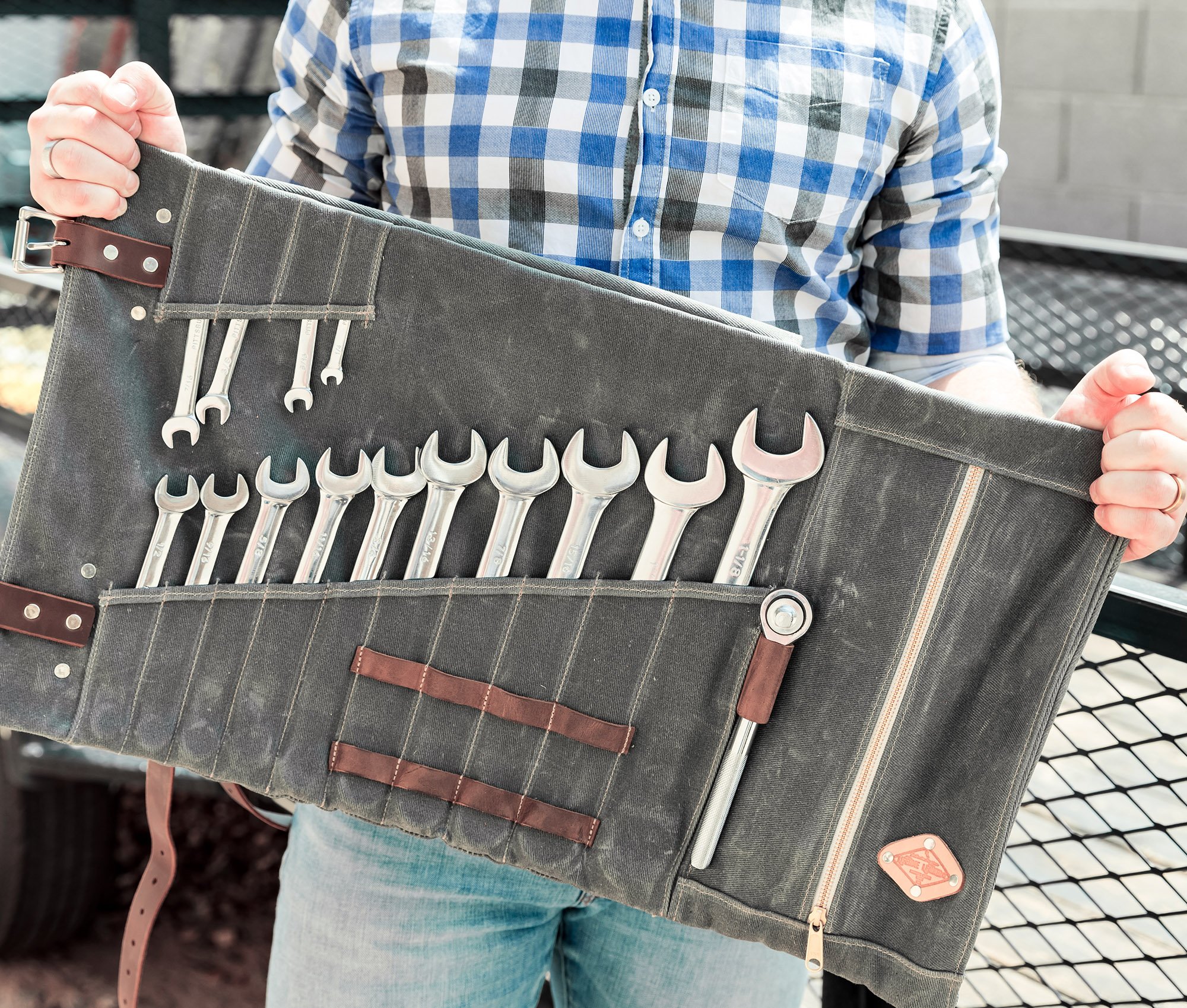 Canvas Tool Roll featuring waxed canvas and leather accents, designed to hold wrenches and tools securely.