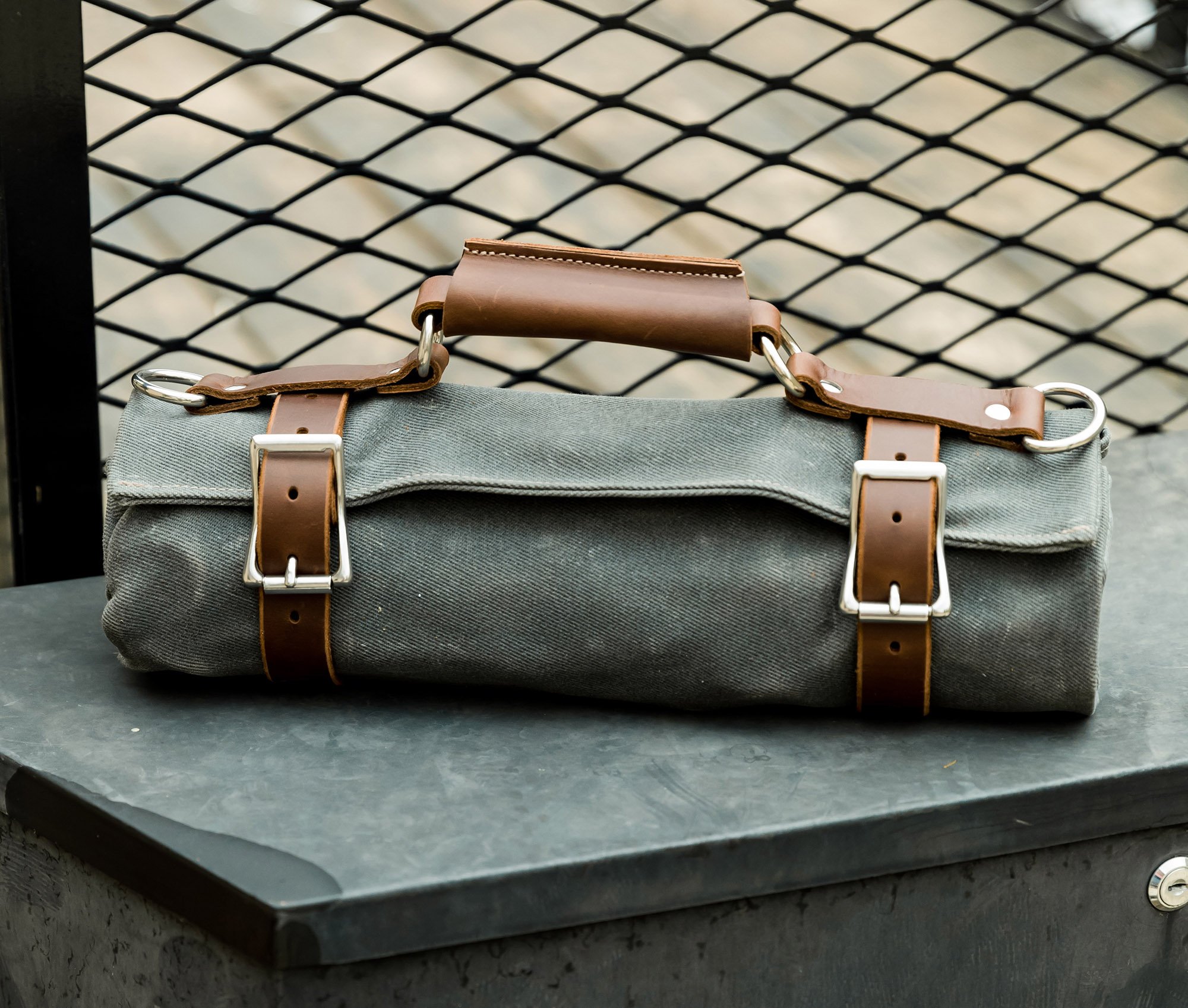 Canvas Tool Roll featuring waxed canvas and leather accents, designed to hold wrenches and tools securely.