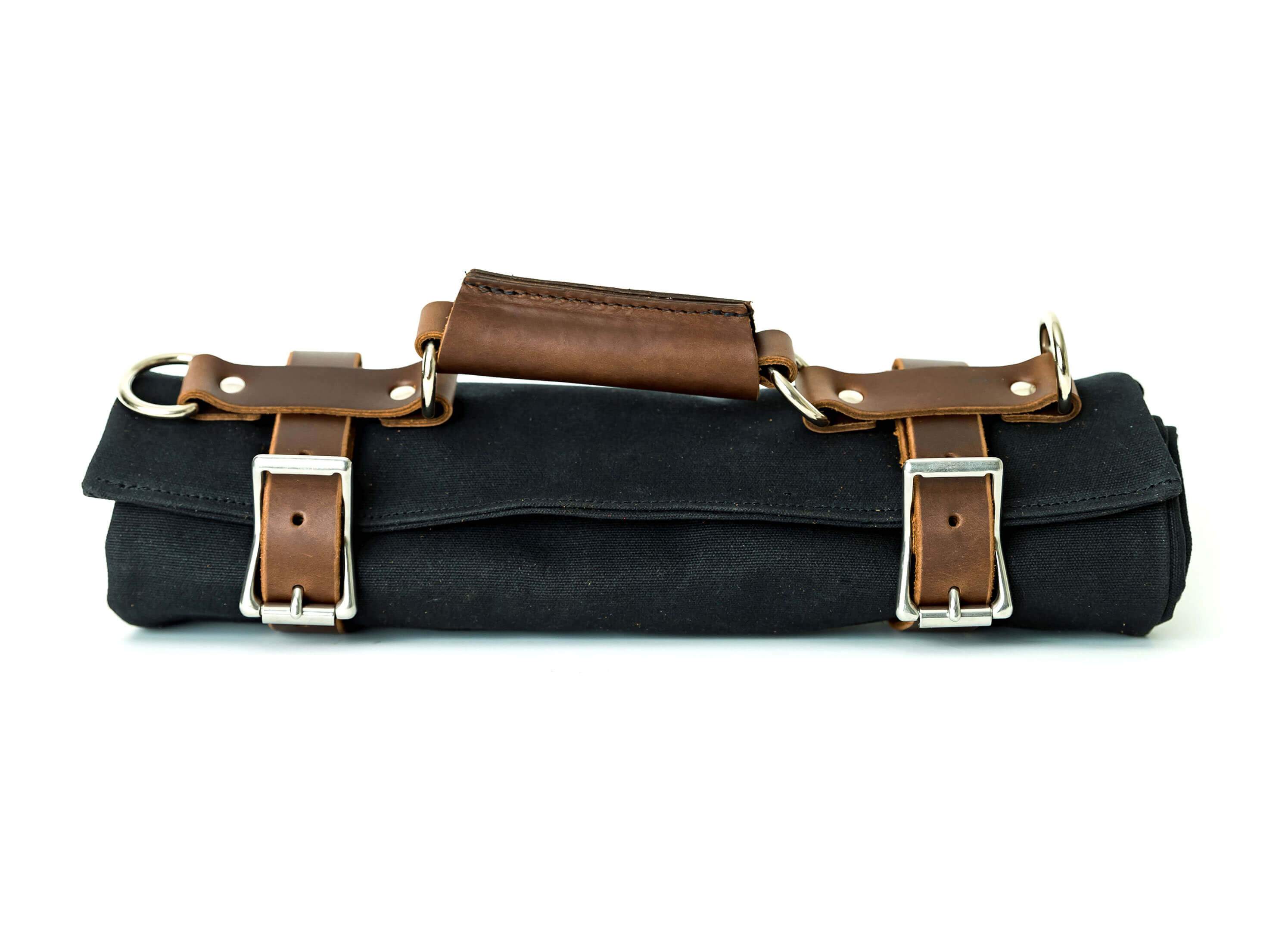 Canvas Tool Roll featuring waxed canvas and leather accents, designed to hold wrenches and tools securely.