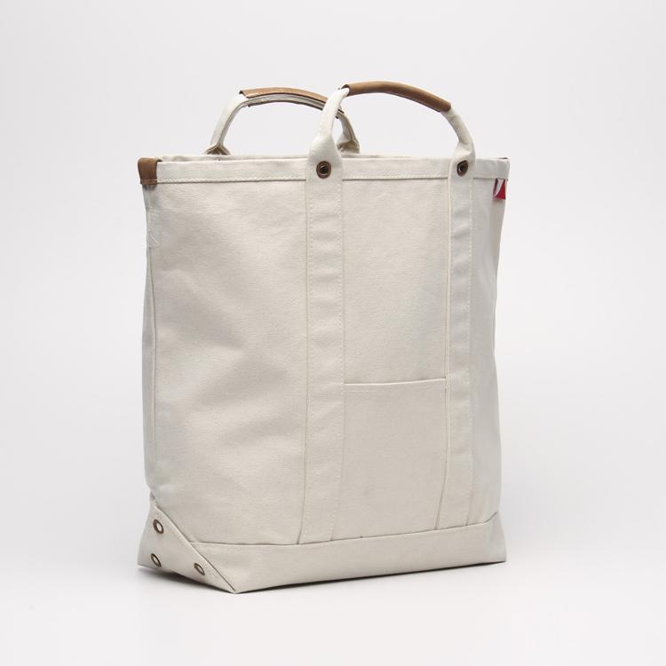 Cargo Carry-On Tote Bag made of heavy cotton canvas with leather accents, featuring a spacious main compartment and outside pockets.