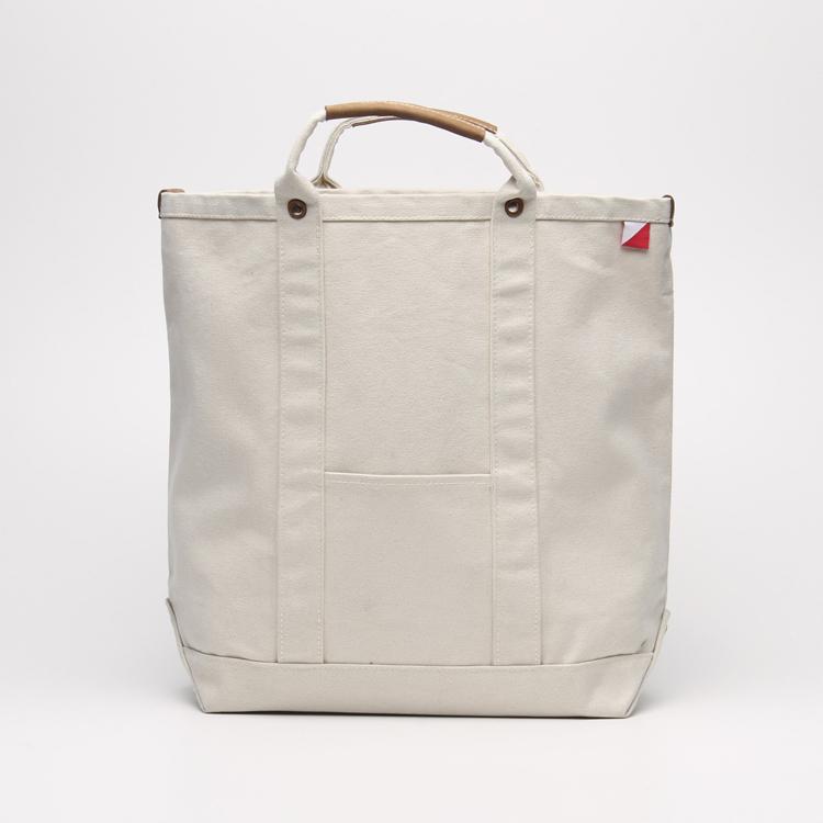 Cargo Carry-On Tote Bag made of heavy cotton canvas with leather accents, featuring a spacious main compartment and outside pockets.