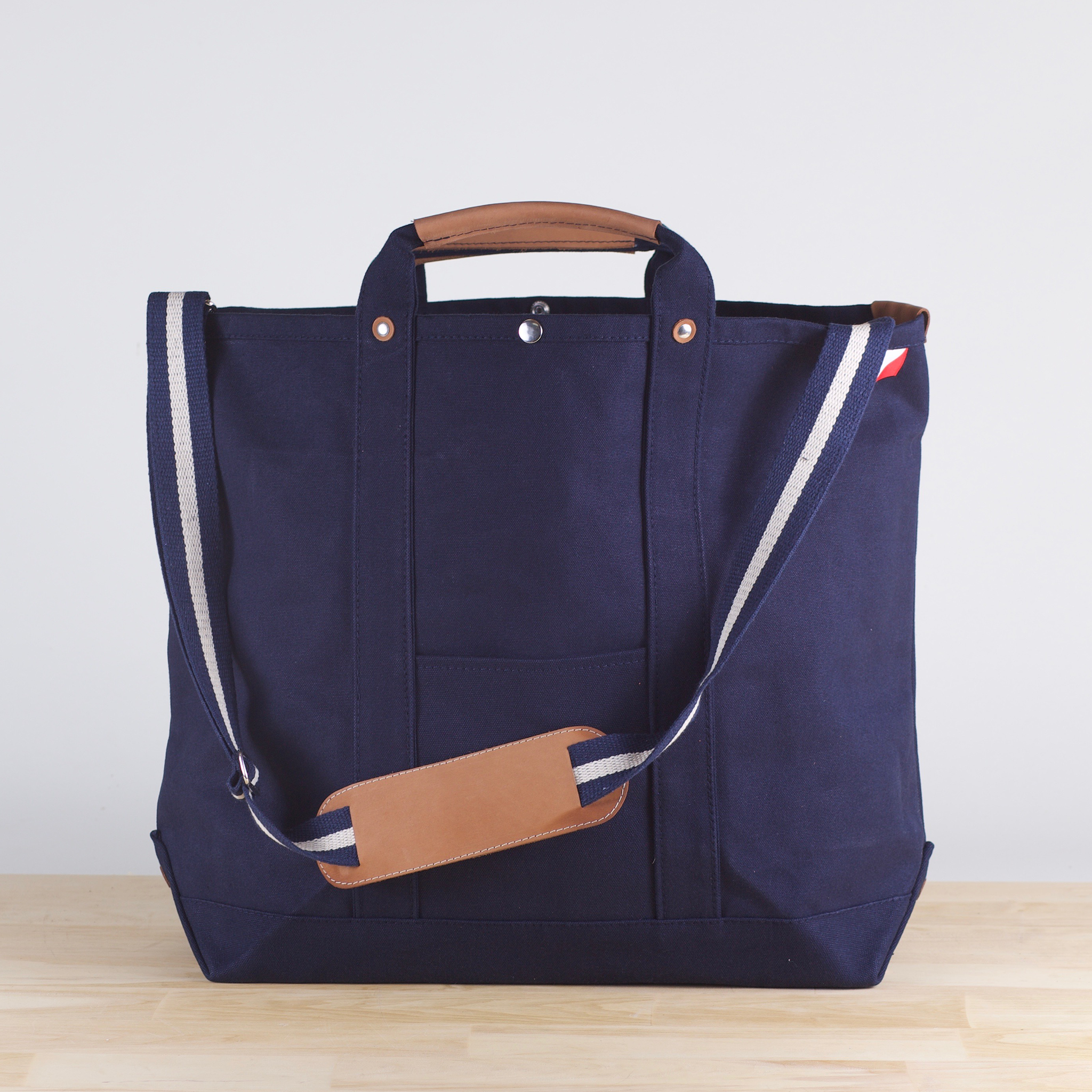 Cargo Carry-On Tote Bag made of heavy cotton canvas with leather accents, featuring a spacious main compartment and outside pockets.