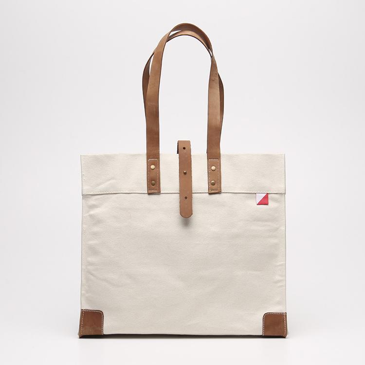 Carmel Tote Bag featuring heavyweight canvas and thick leather handles, designed for outdoor gatherings.