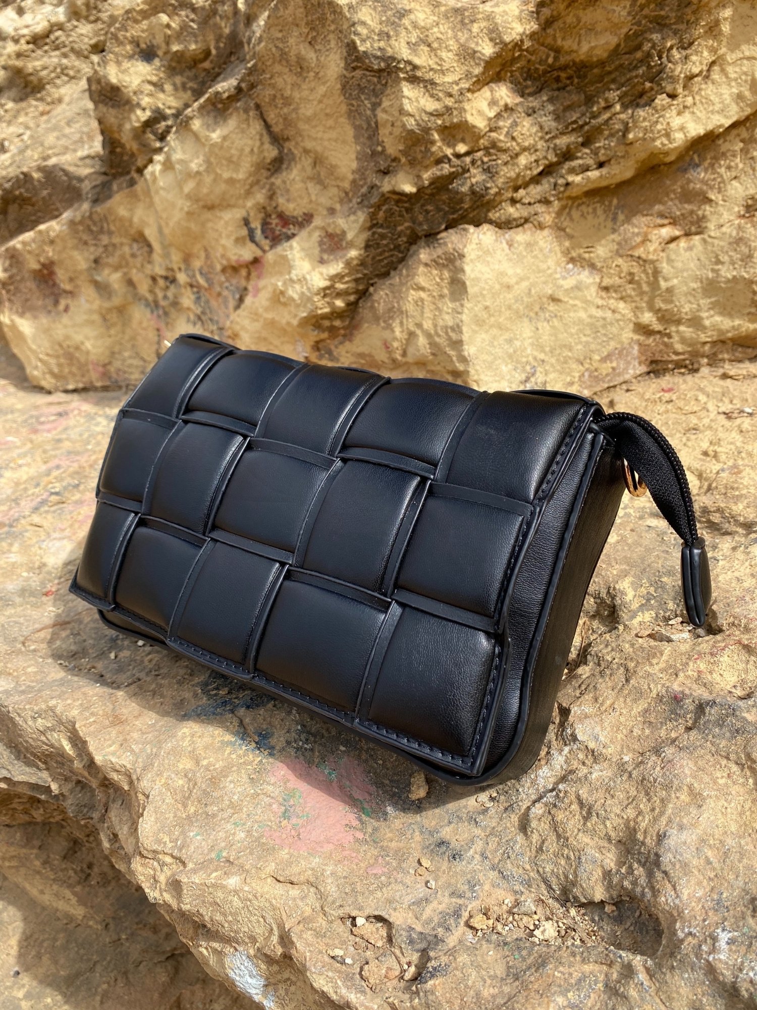 Stylish black Cassette Shoulder Bag with quilted flap and adjustable strap, showcasing its elegant design and functional features.