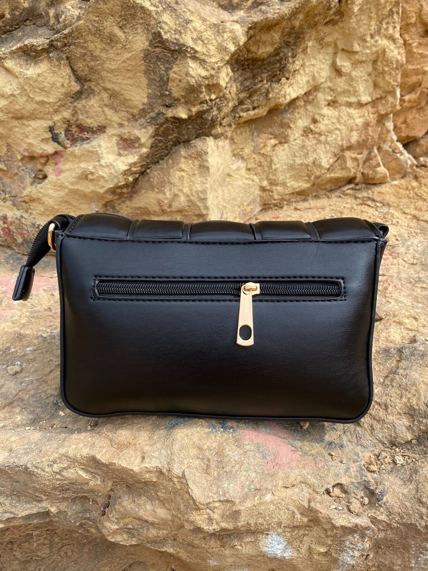 Stylish black Cassette Shoulder Bag with quilted flap and adjustable strap, showcasing its elegant design and functional features.