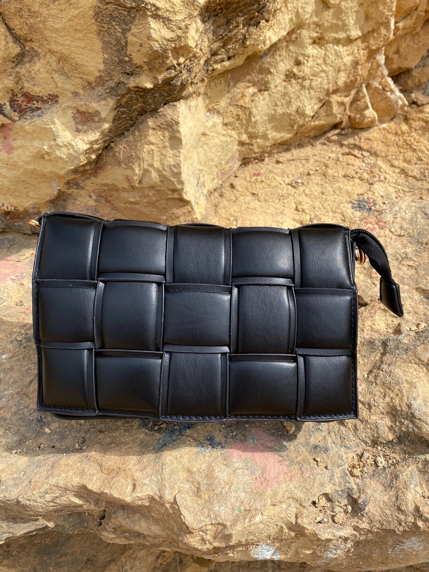 Stylish black Cassette Shoulder Bag with quilted flap and adjustable strap, showcasing its elegant design and functional features.