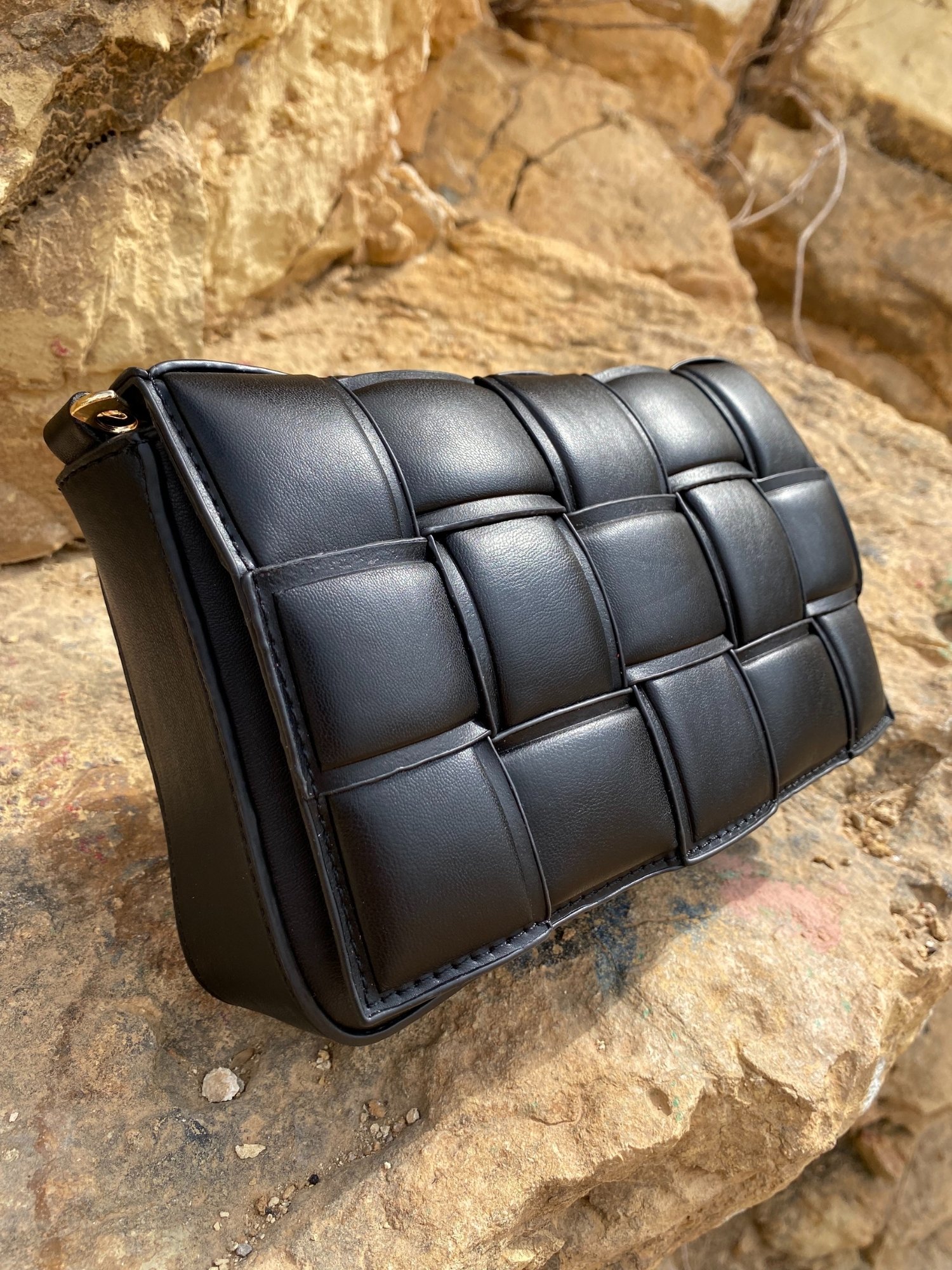 Stylish black Cassette Shoulder Bag with quilted flap and adjustable strap, showcasing its elegant design and functional features.