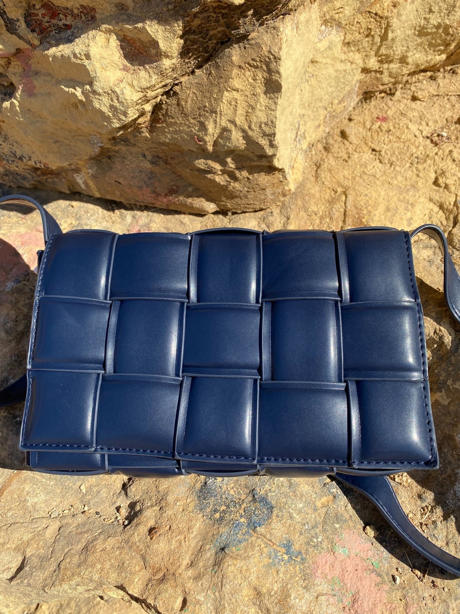 Blue Cassette Shoulder Bag with quilted flap and adjustable strap, featuring a lined interior and magnetic closure.