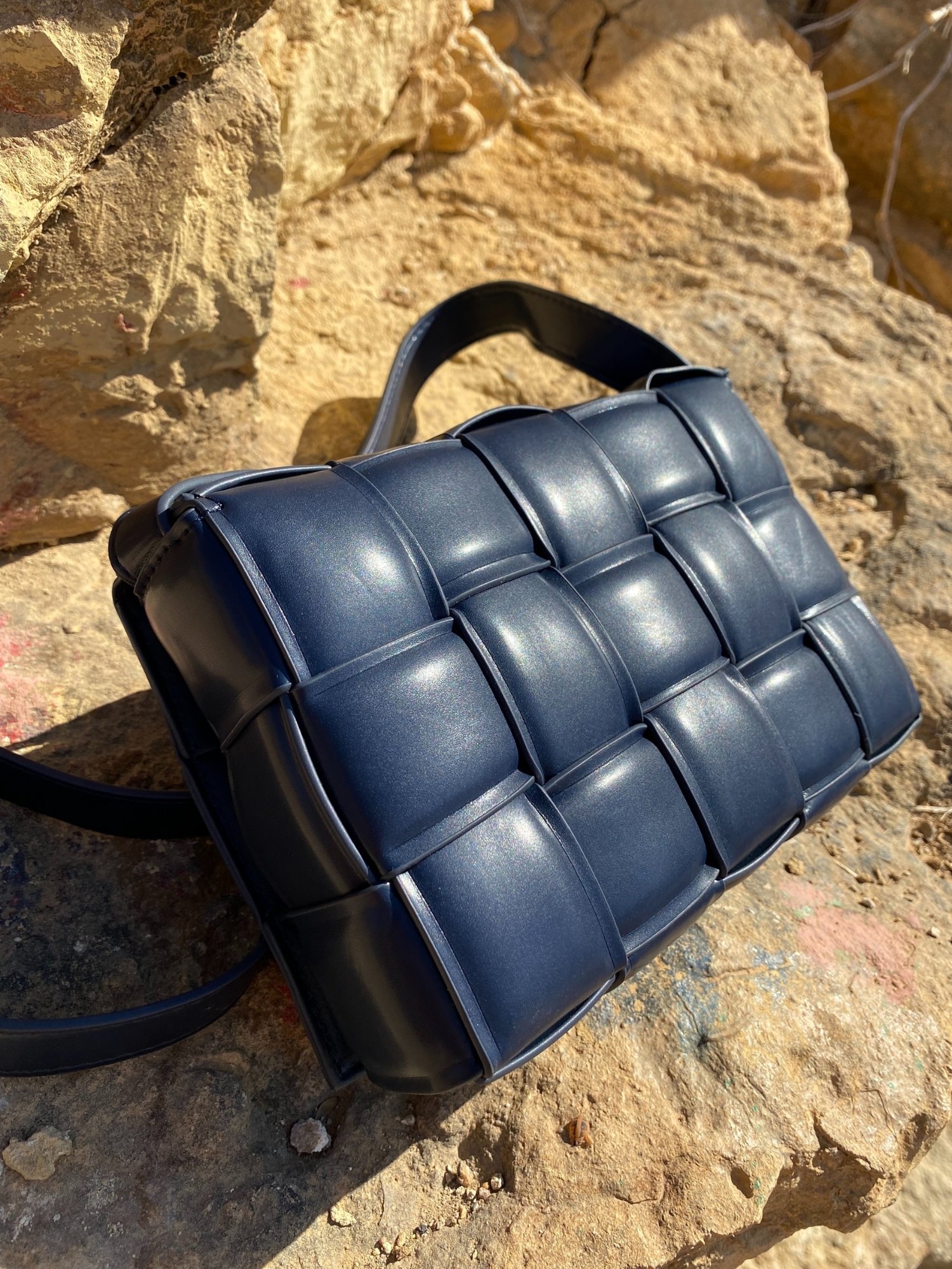 Blue Cassette Shoulder Bag with quilted flap and adjustable strap, featuring a lined interior and magnetic closure.