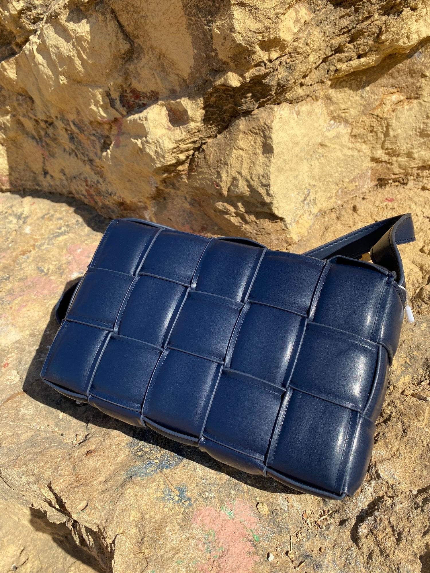 Blue Cassette Shoulder Bag with quilted flap and adjustable strap, featuring a lined interior and magnetic closure.