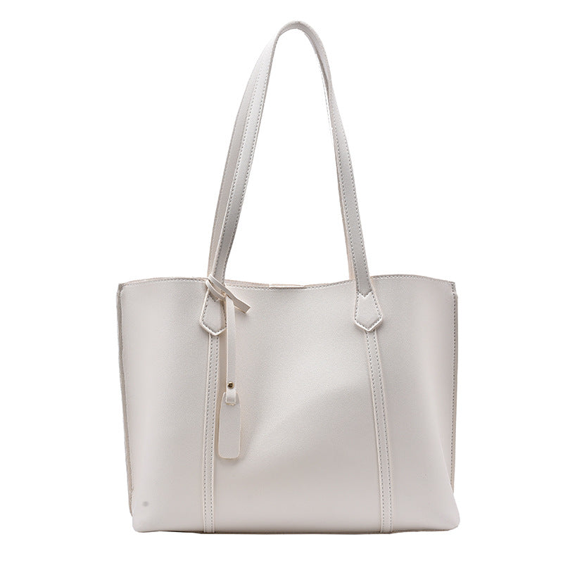 A stylish Casual All-match One-shoulder Handbag for Women made of soft PU fabric, featuring a horizontal square shape and a magnetic button closure.