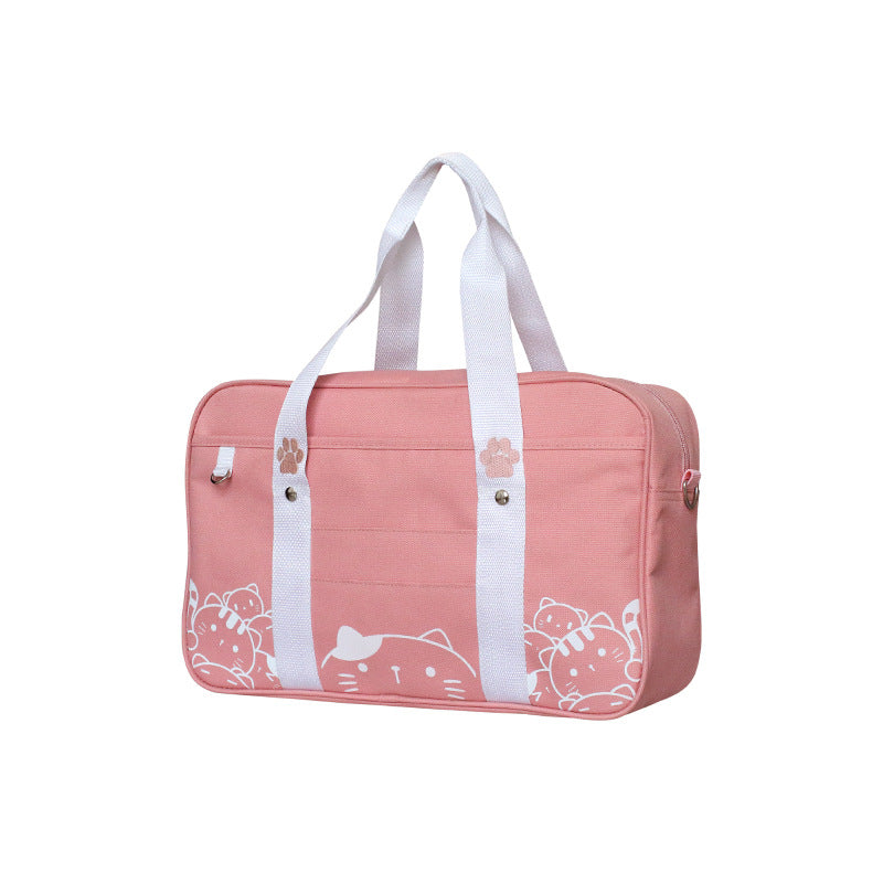 A stylish portable canvas handbag featuring a charming cat pattern, designed for ladies, showcasing its spacious interior and durable fabric.