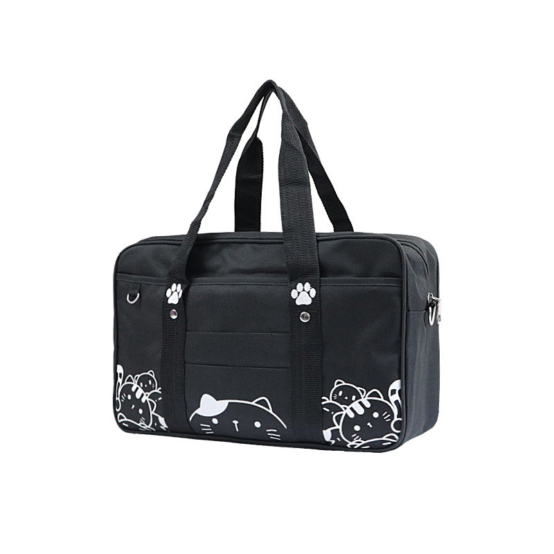 A stylish portable canvas handbag featuring a charming cat pattern, designed for ladies, showcasing its spacious interior and durable fabric.