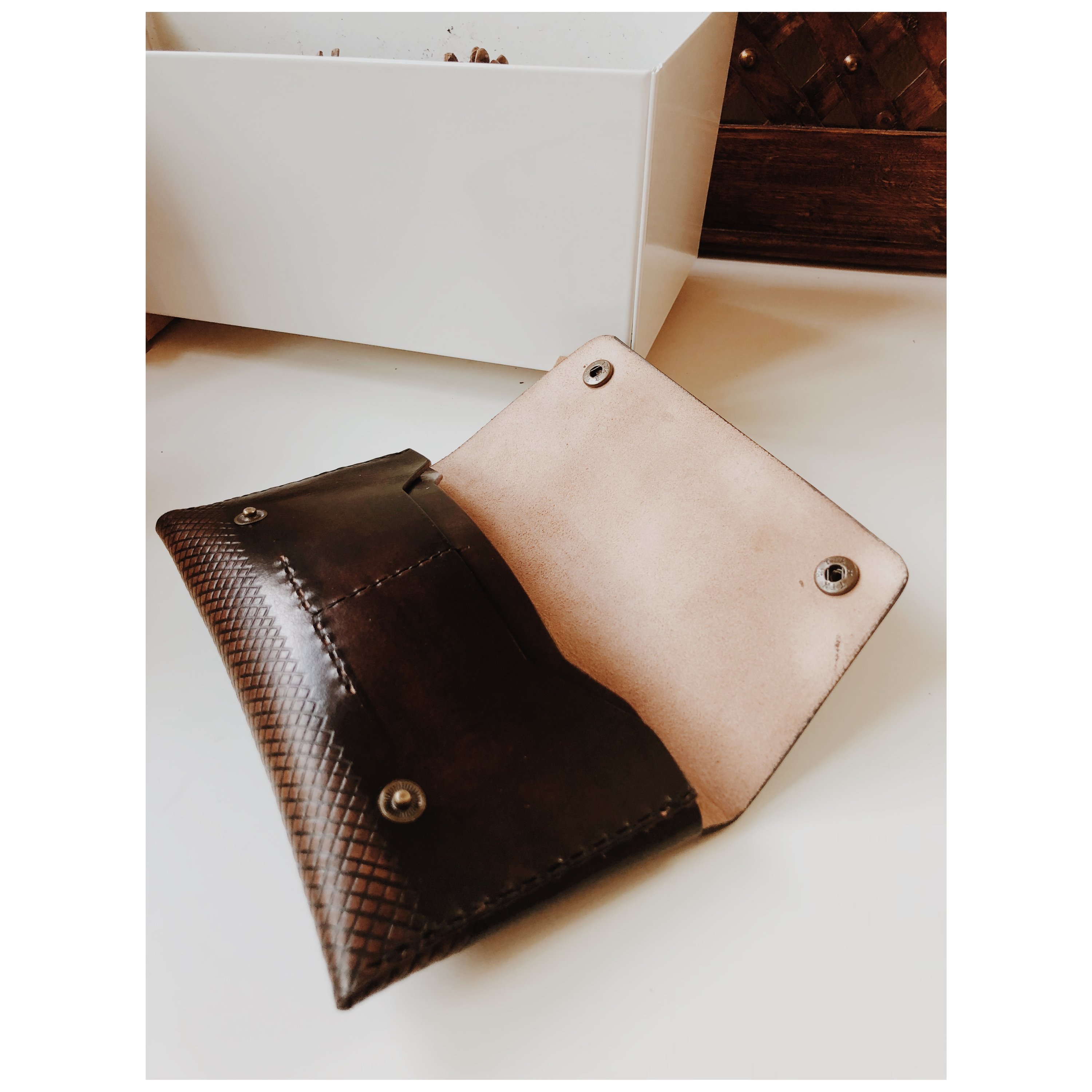 COAL Clutch made from vegetable-tanned leather, featuring a rectangular design with card pockets and a spacious interior for a smartphone.