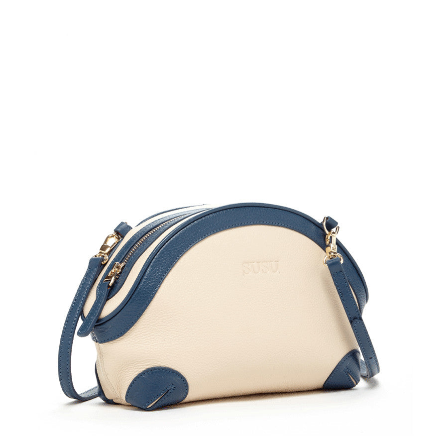 Coco Ivory Leather Crossbody Bag featuring pebbled texture, gold hardware, and adjustable strap.