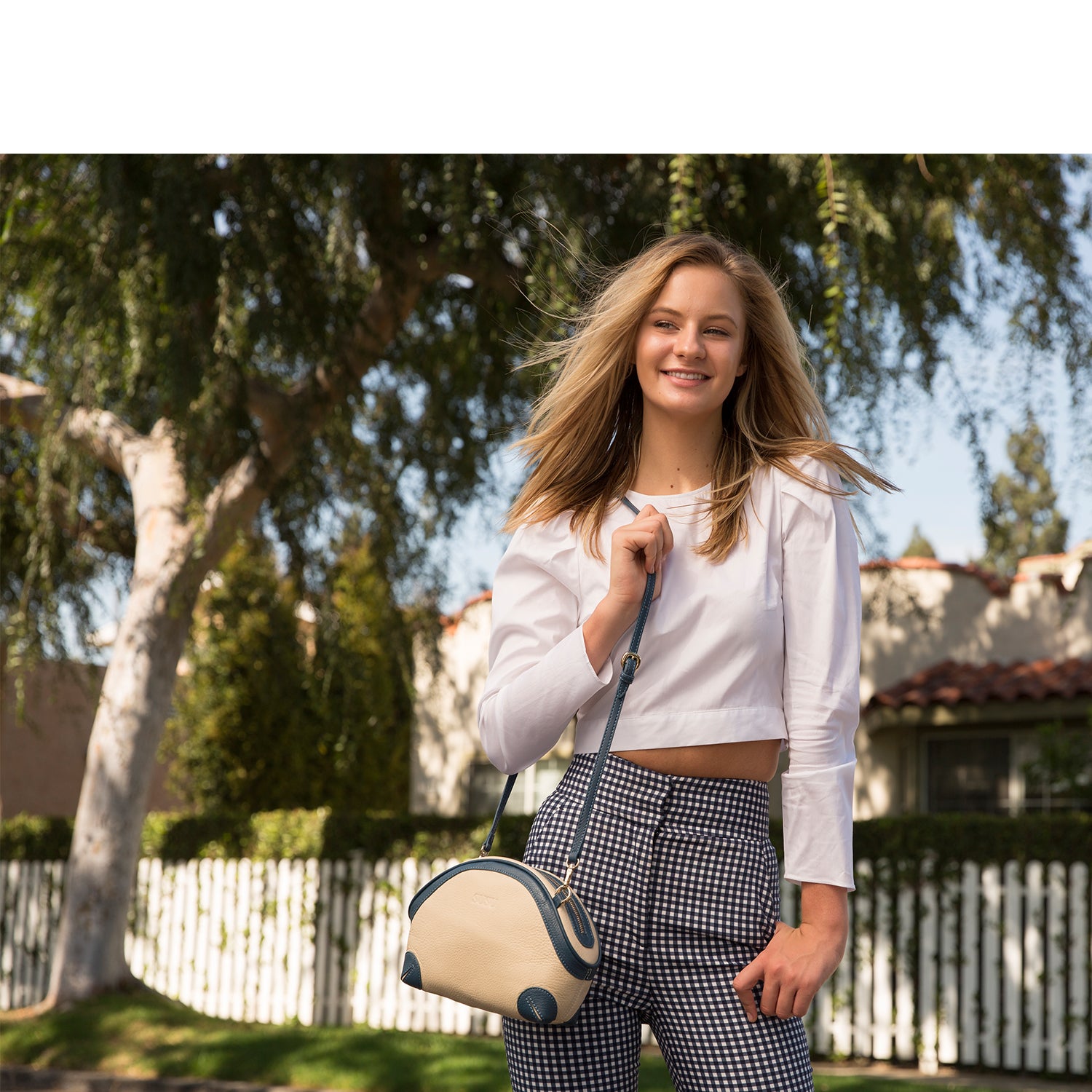 Coco Ivory Leather Crossbody Bag featuring pebbled texture, gold hardware, and adjustable strap.