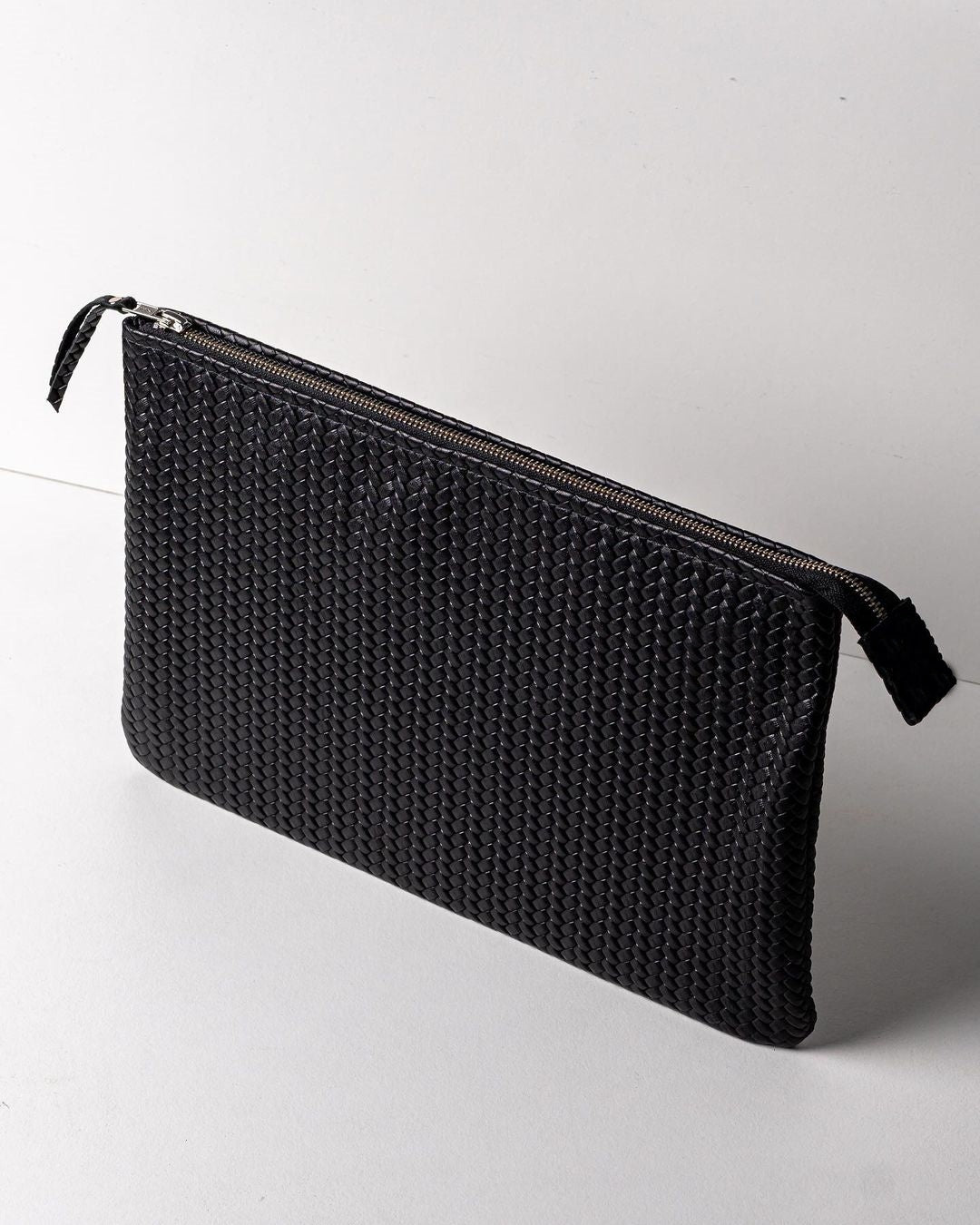 Coffer Mini Handwoven Leather Zipper Clutch in natural leather, showcasing its handwoven texture and compact size.