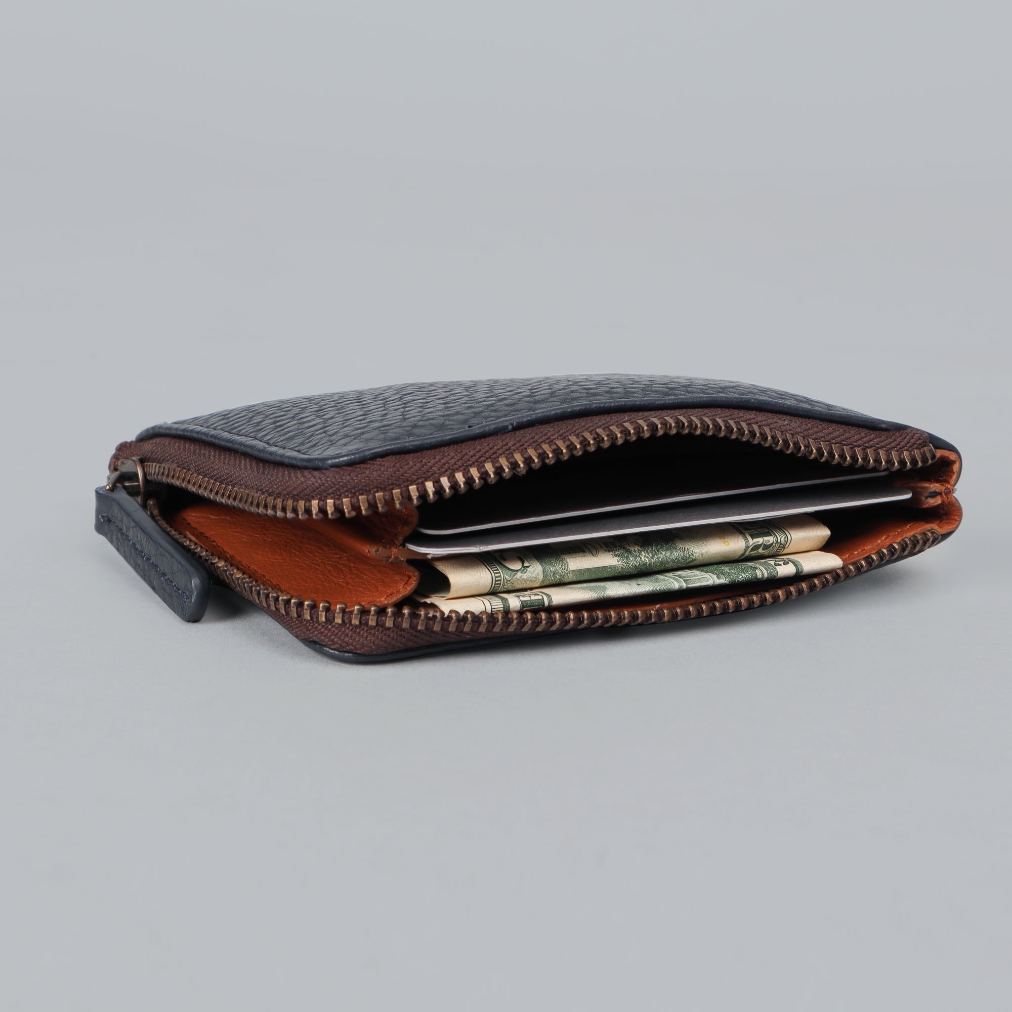 A stylish Coins Wallet made from durable harness leather, featuring a zipper closure and multiple pockets for coins and cards.