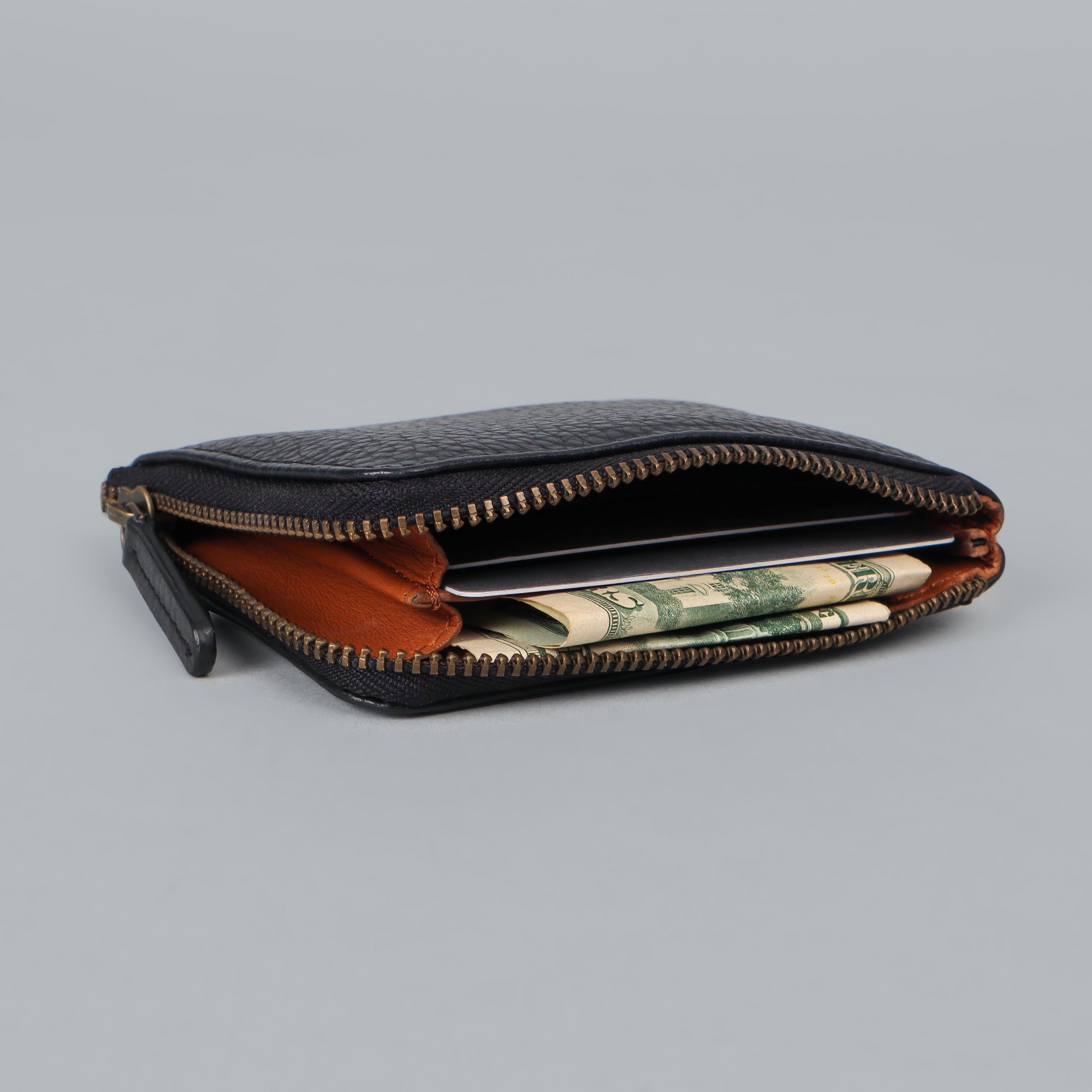 A stylish Coins Wallet made from durable harness leather, featuring a zipper closure and multiple pockets for coins and cards.