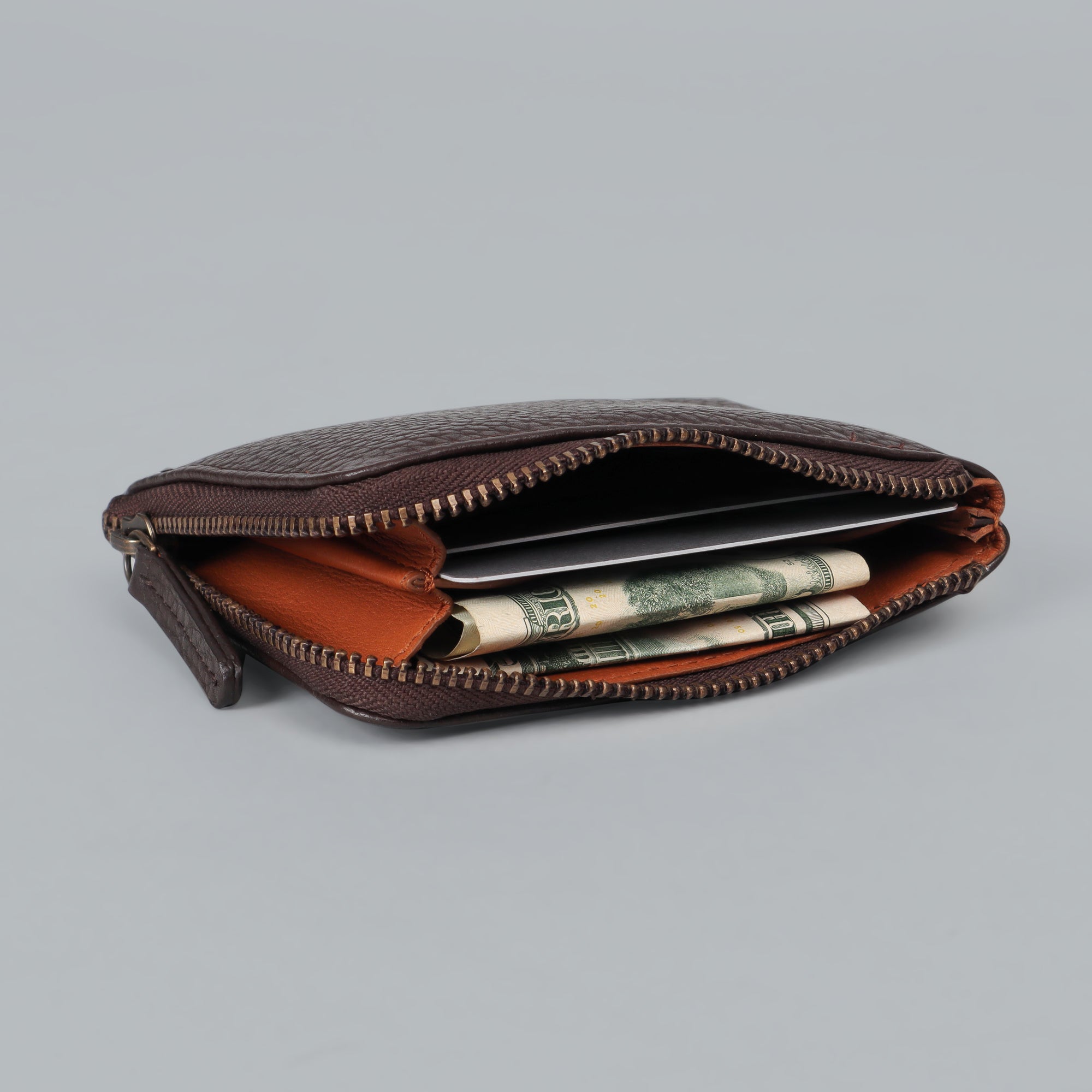 A handcrafted Coins Wallet made from durable harness leather, featuring a zipper closure and multiple pockets for coins and cards.