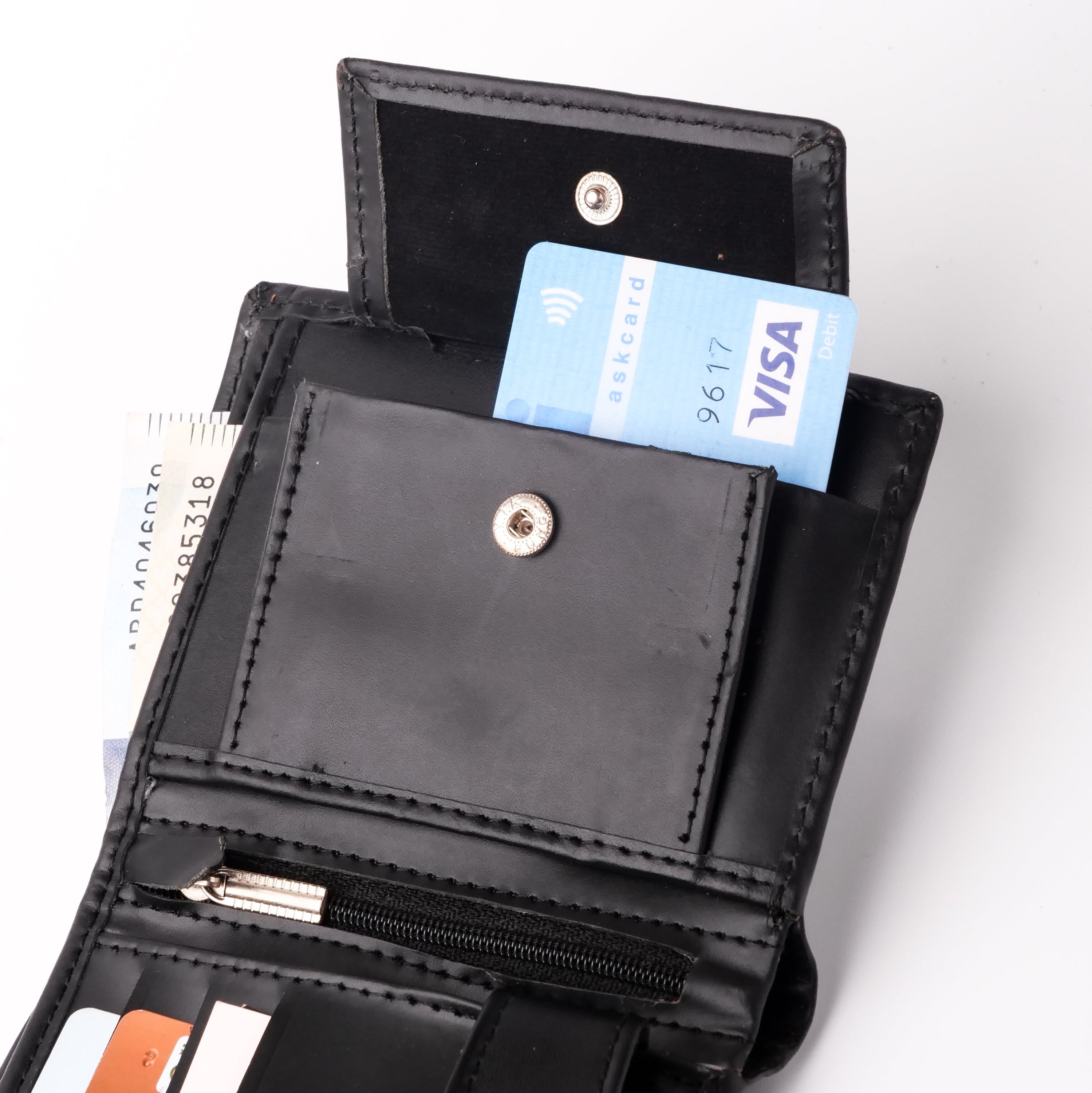 Compact Black Leather Wallet featuring multiple card slots and a coin pocket, elegantly designed for convenience and style.