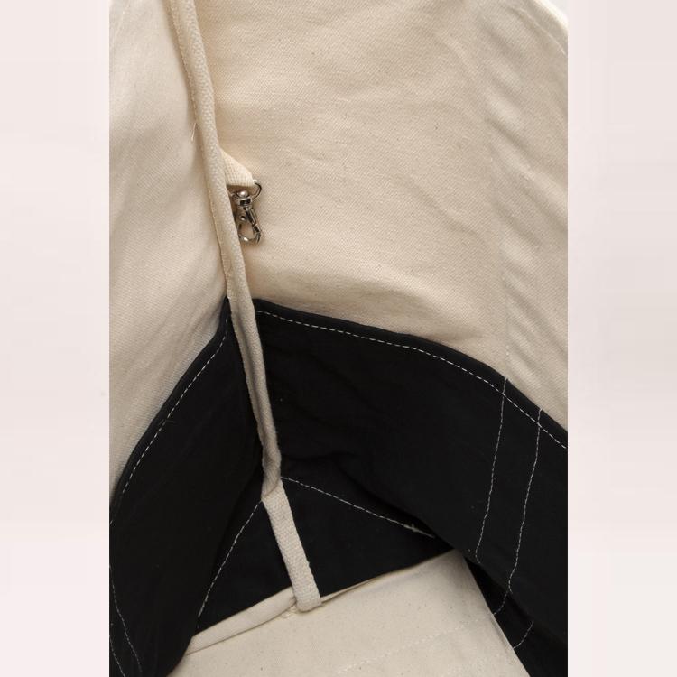 A large contemporary tote bag featuring a diagonal sail design, reinforced handles, and multiple interior pockets for organization.