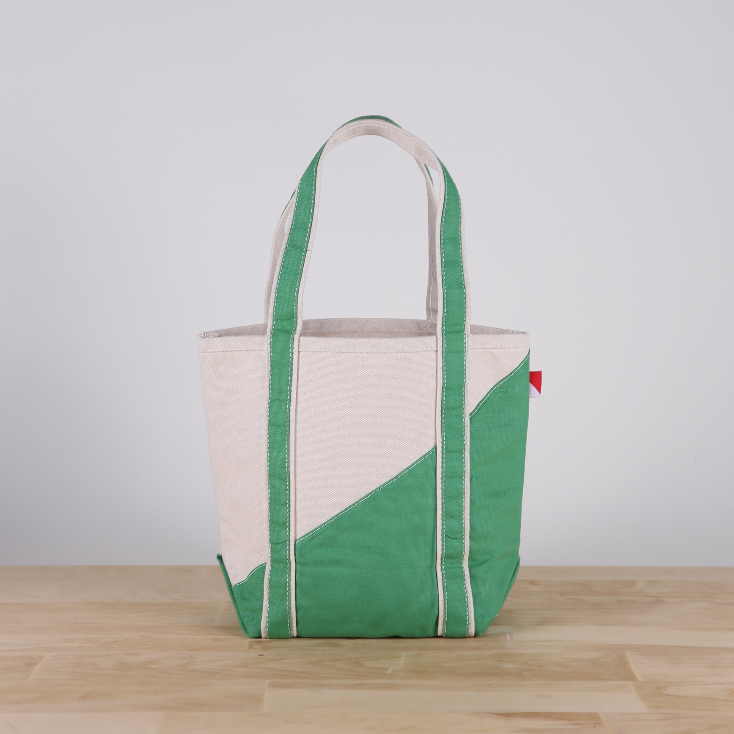 A stylish Contemporary Tote Bag Mini in vibrant colors, showcasing its durable construction and compact design, perfect for gifts and everyday use.