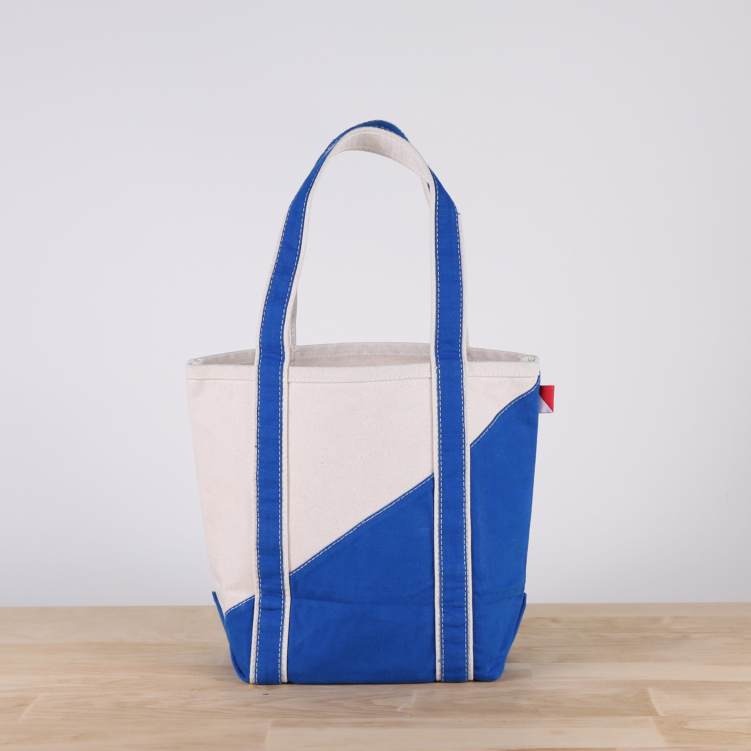 A stylish Contemporary Tote Bag Mini in vibrant colors, showcasing its durable construction and compact design, perfect for gifts and everyday use.