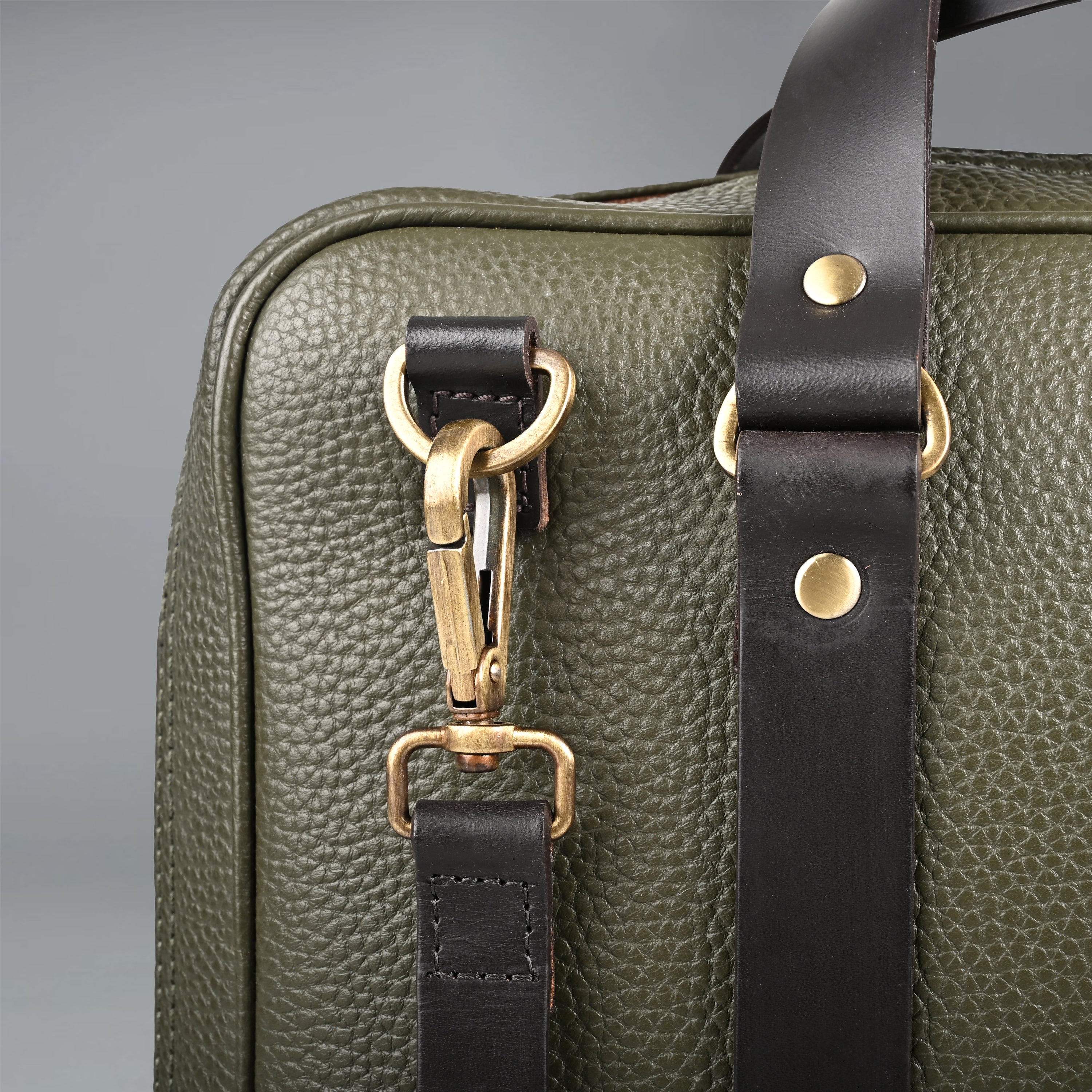 The Creek Briefcase made from premium leather, featuring a padded laptop section and multiple storage pockets.