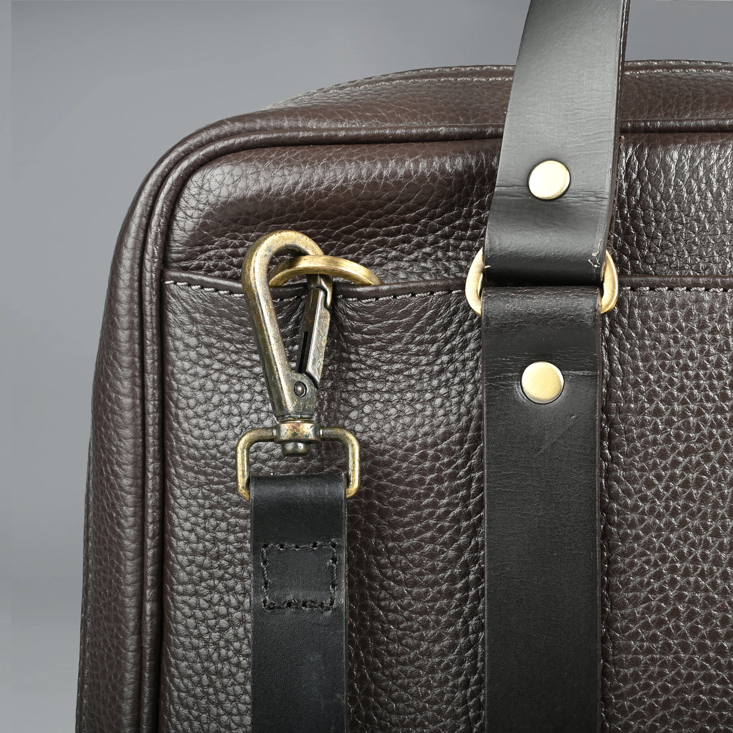 The Creek Briefcase made from premium leather, featuring a padded laptop compartment and multiple storage pockets.