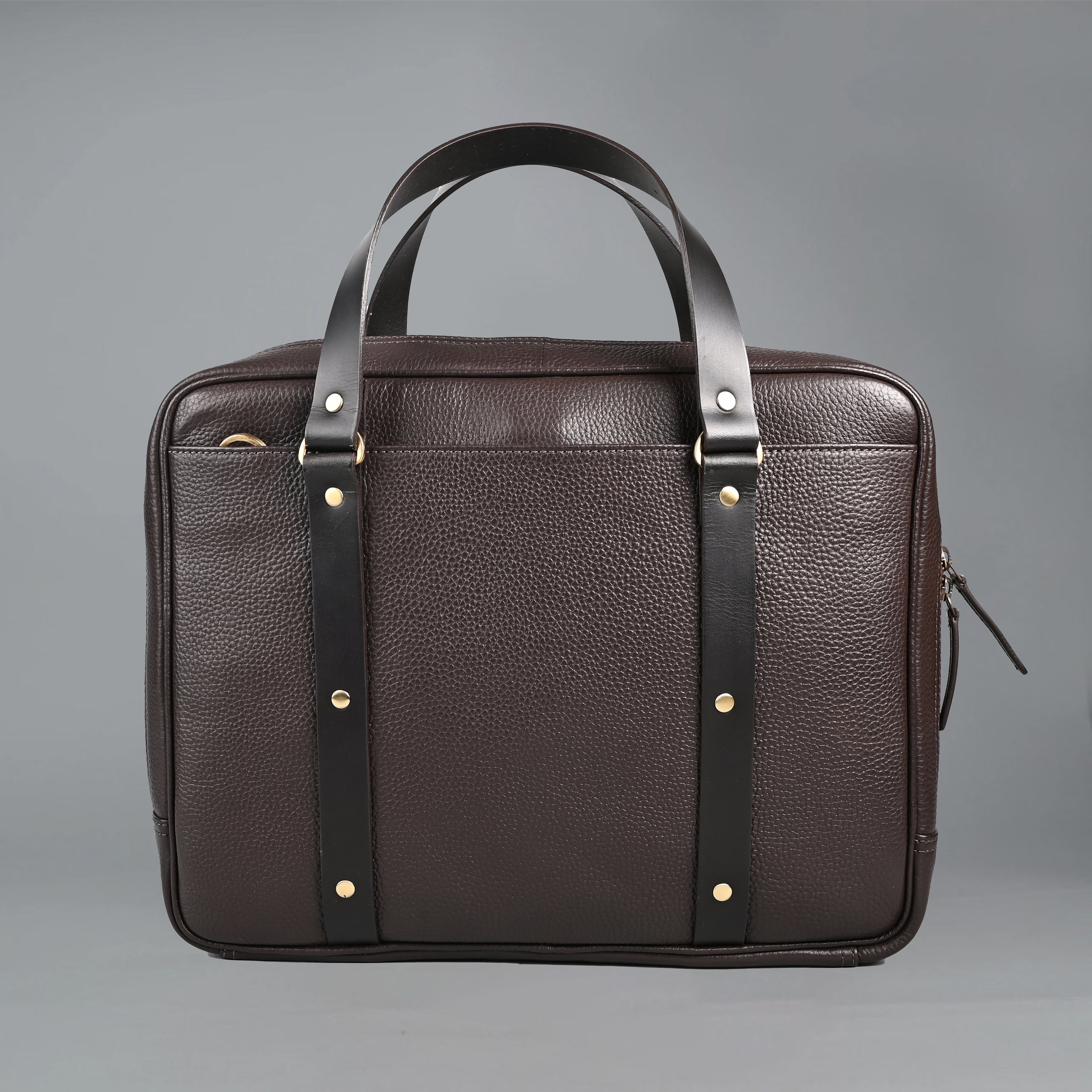 The Creek Briefcase made from premium leather, featuring a padded laptop compartment and multiple storage pockets.