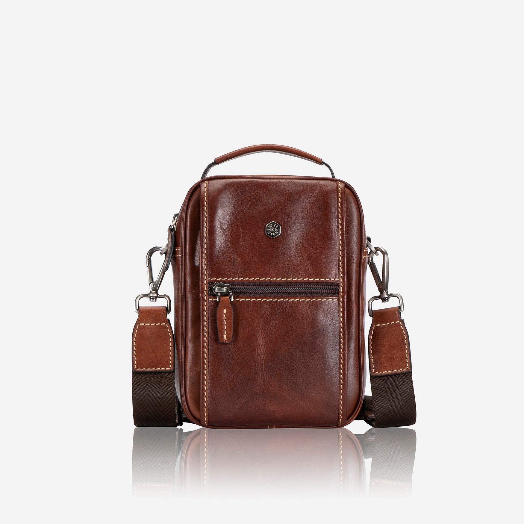 Stylish tobacco crossbody bag with adjustable strap and spacious interior.