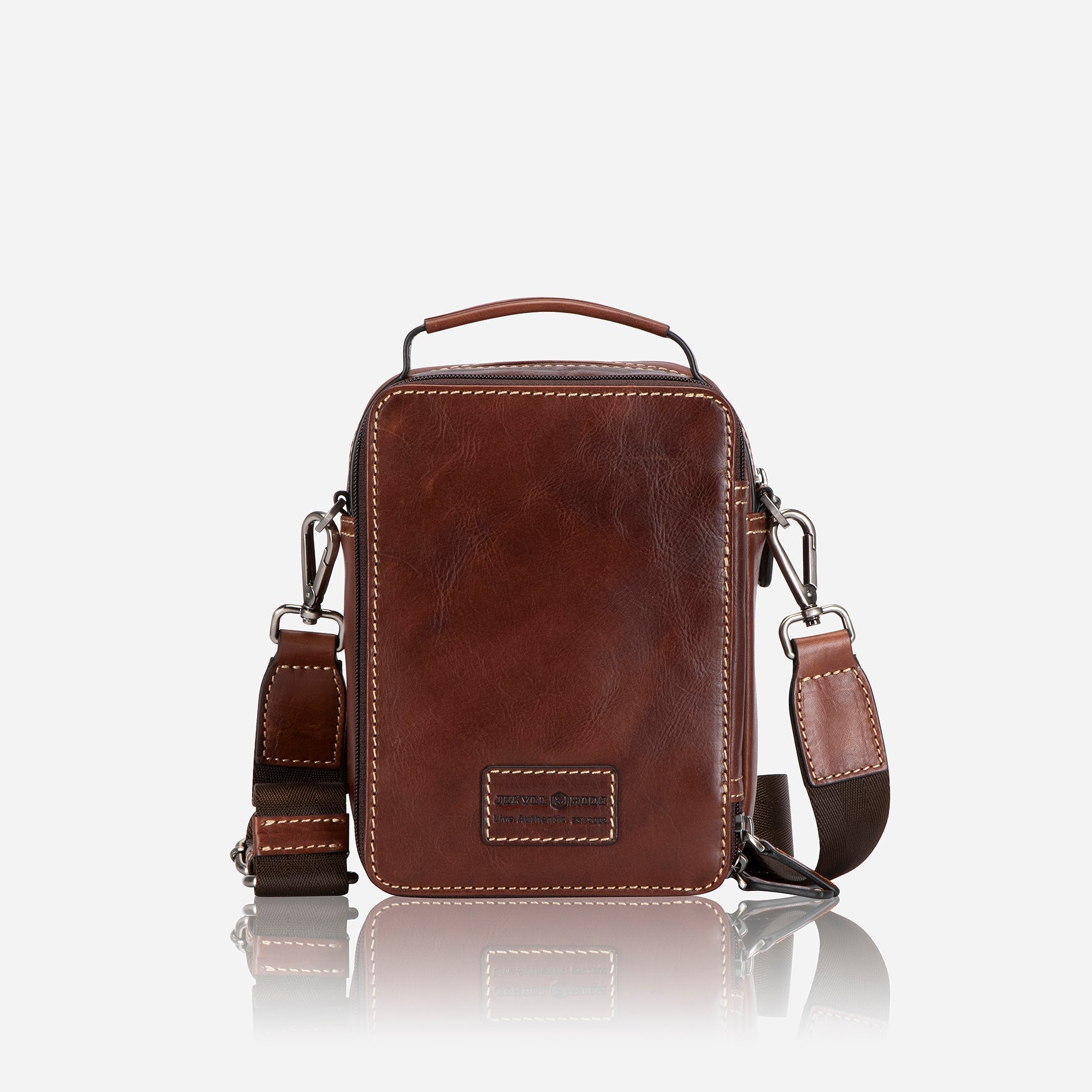 Stylish tobacco crossbody bag with adjustable strap and spacious interior.