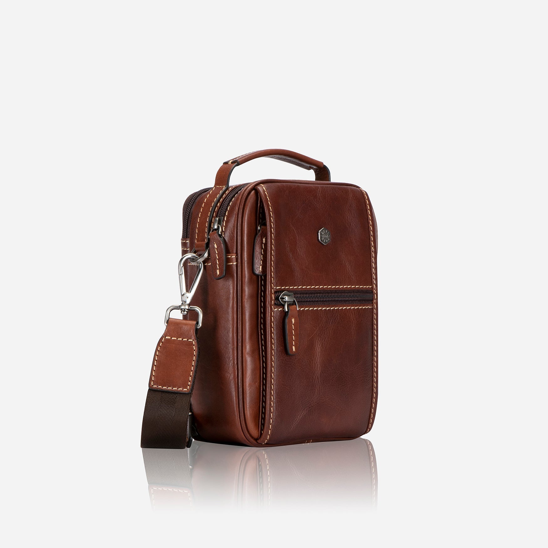 Stylish tobacco crossbody bag with adjustable strap and spacious interior.