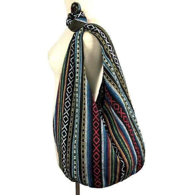 Crossbody Tribal Ethnic Vintage bag made from high-quality tribal fabric with a wooden button closure and a long strap.