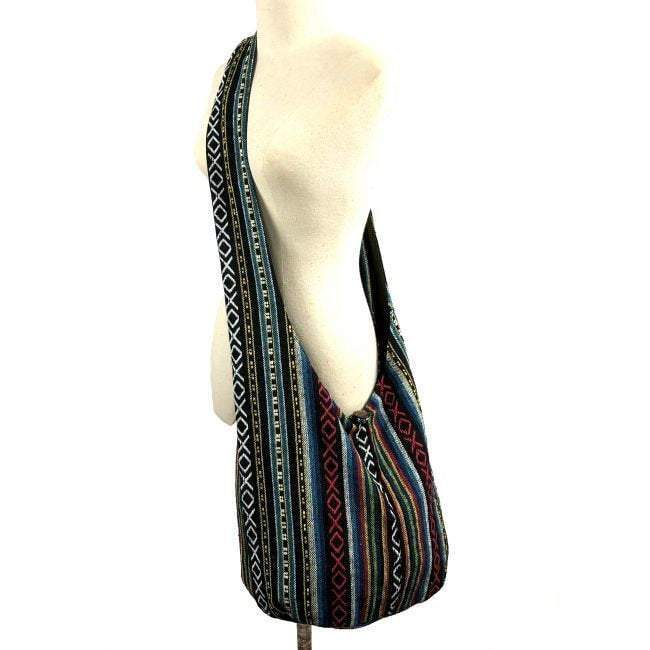 Crossbody Tribal Ethnic Vintage bag made from high-quality tribal fabric with a wooden button closure and a long strap.