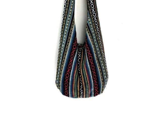 Crossbody Tribal Ethnic Vintage bag made from high-quality tribal fabric with a wooden button closure and a long strap.