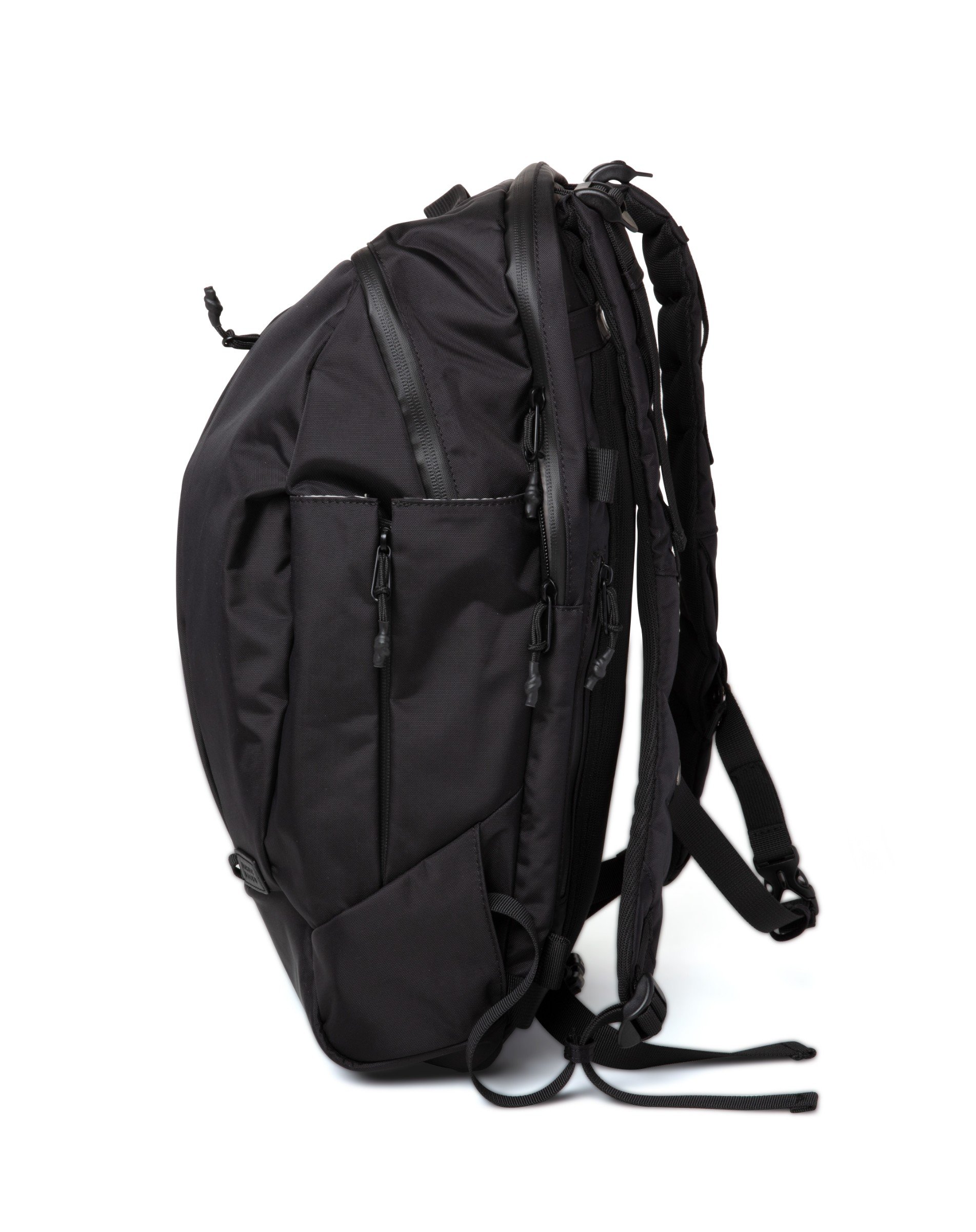 Cus Black Backpack featuring water-repellent nylon, spacious compartments, and removable accessories for versatile use.