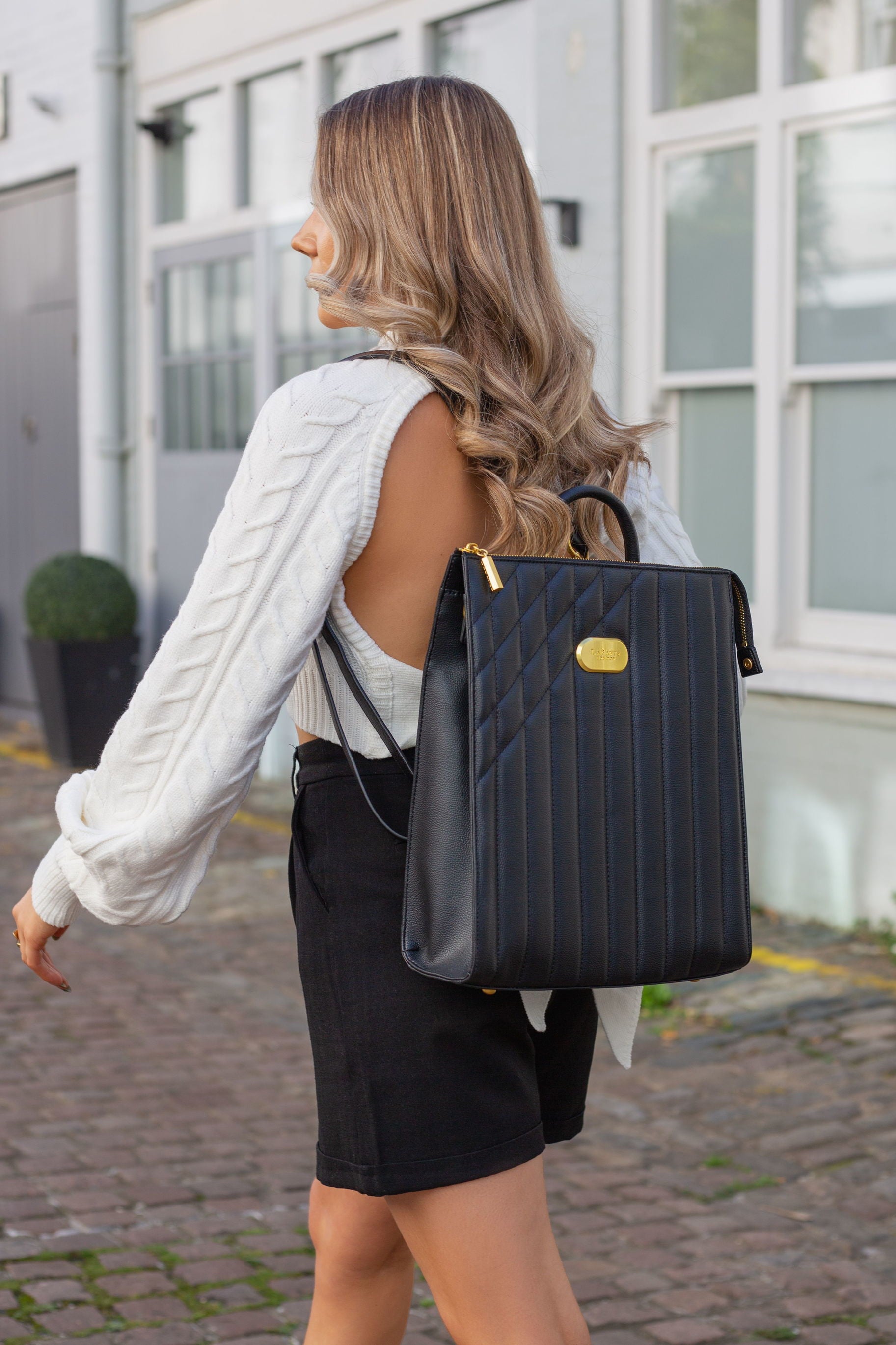 Danai Backpack in Black featuring Iris Scott's impressionist designs, showcasing its stylish straps and spacious compartments.