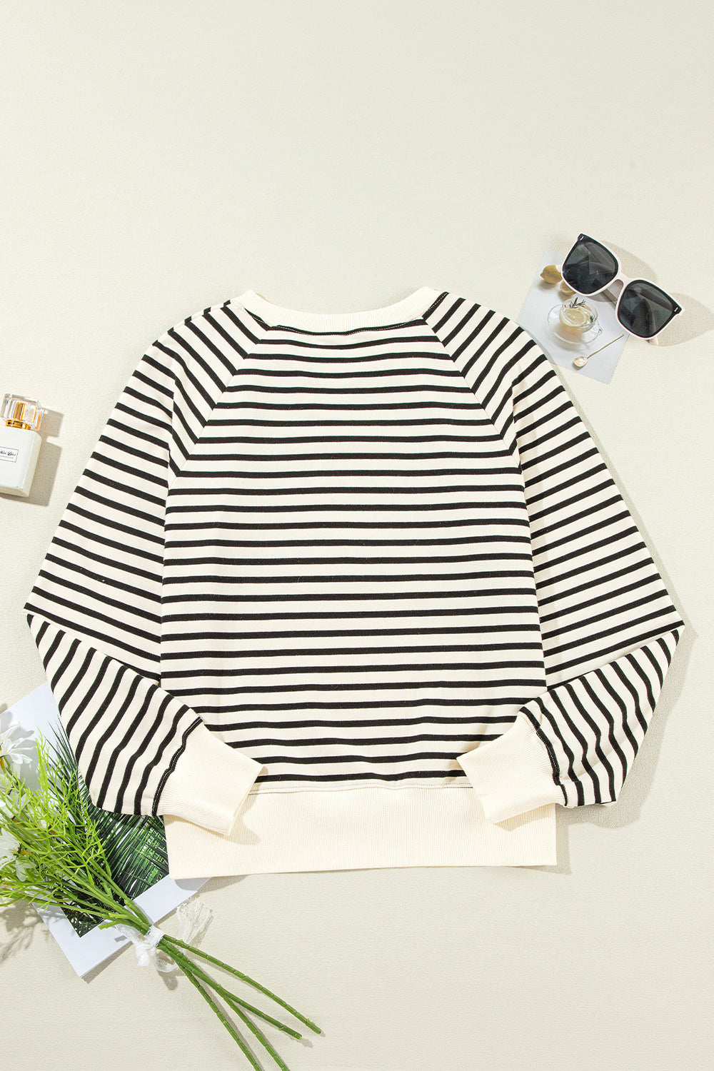 A stylish Decorative Button Striped Long Sleeve Sweatshirt featuring decorative buttons, soft fabric, and a trendy striped pattern.